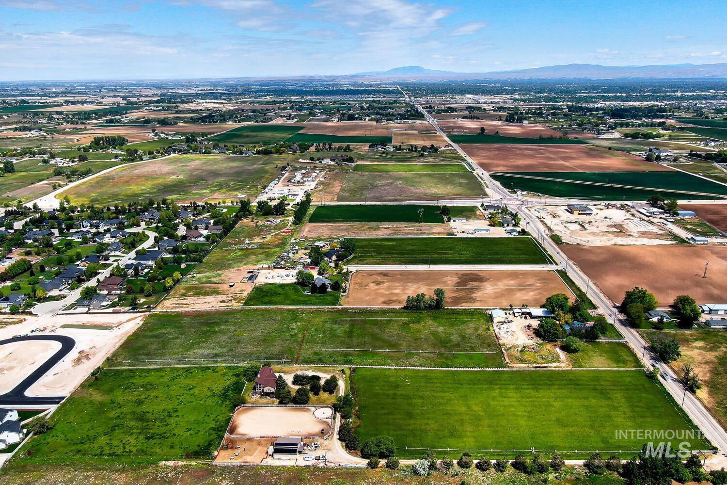 Aerial overview of property's location featuring a mountain backdrop