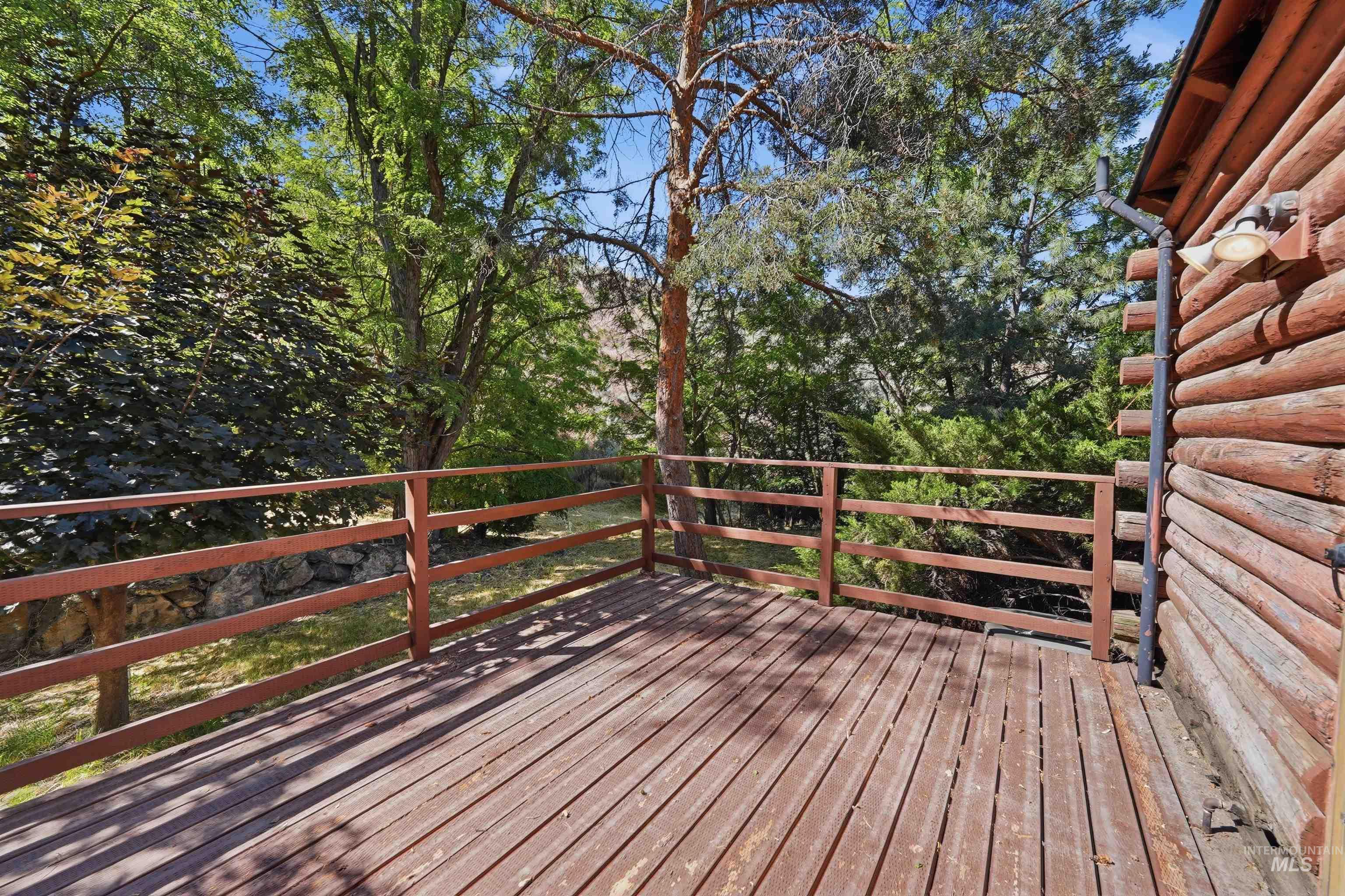 Spacious wood-plank deck with a perimeter railing