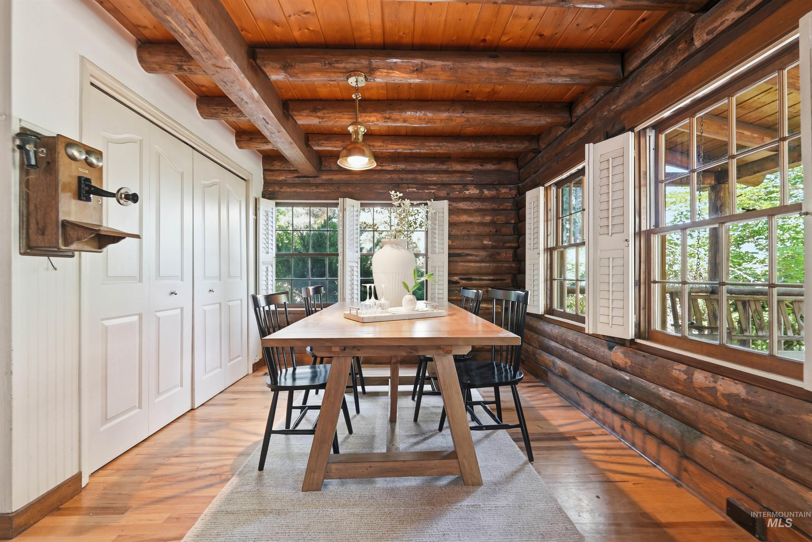 Exposed wood log walls complement the natural wood-finish ceiling and flooring