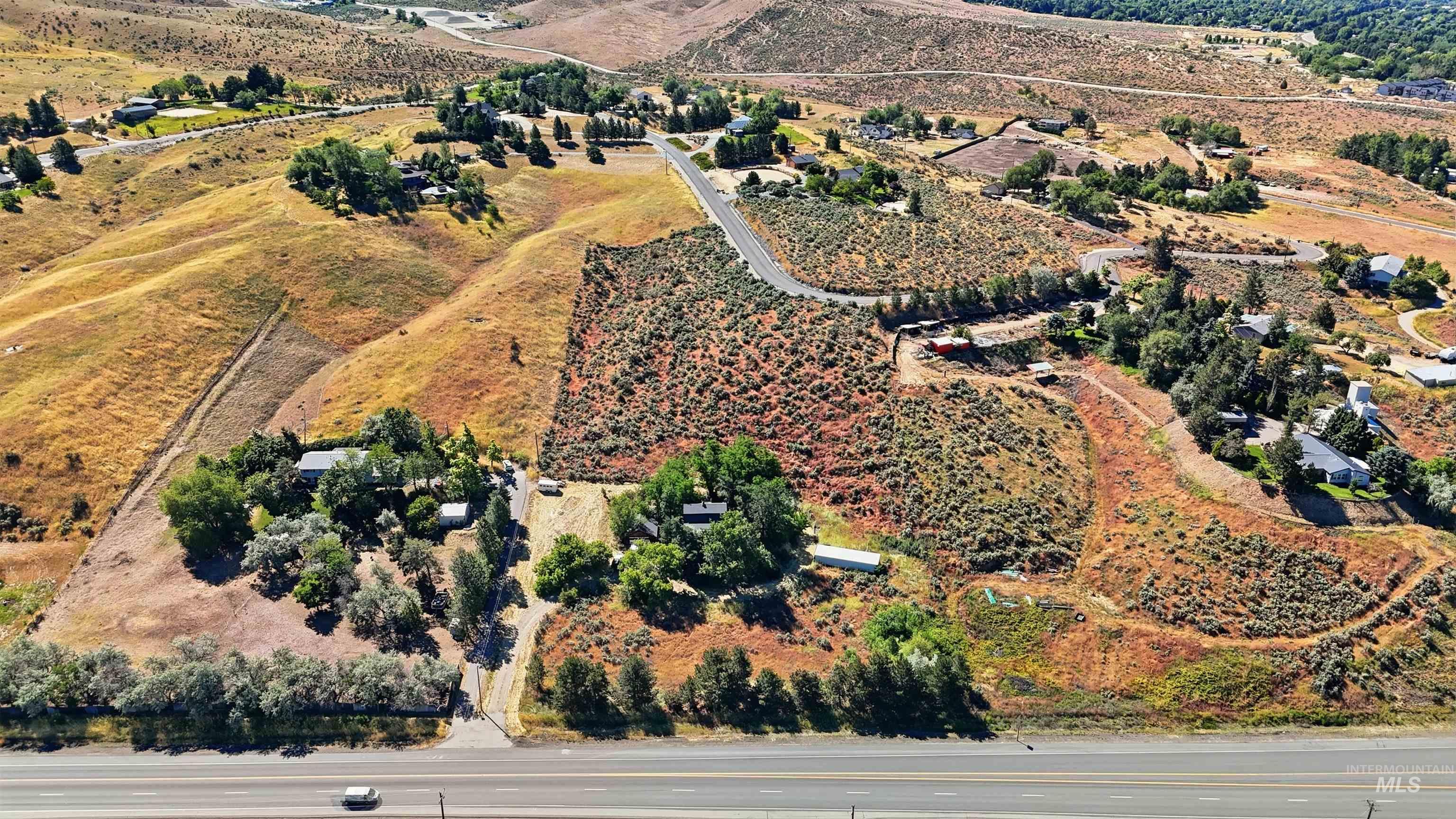 Expansive property featuring varied terrain, including flat areas and sloped hillsides