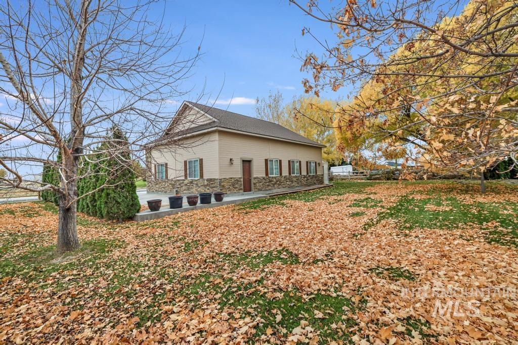 View of side of property with stone siding and a patio area