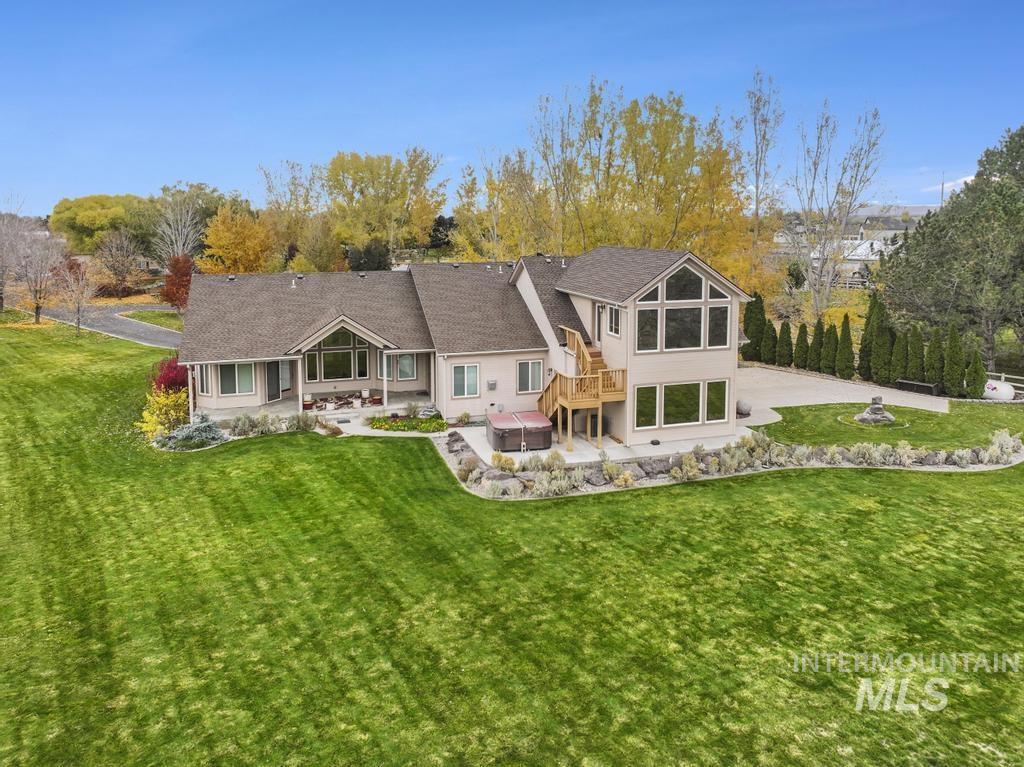 Back of property featuring a yard, a patio, and stucco siding