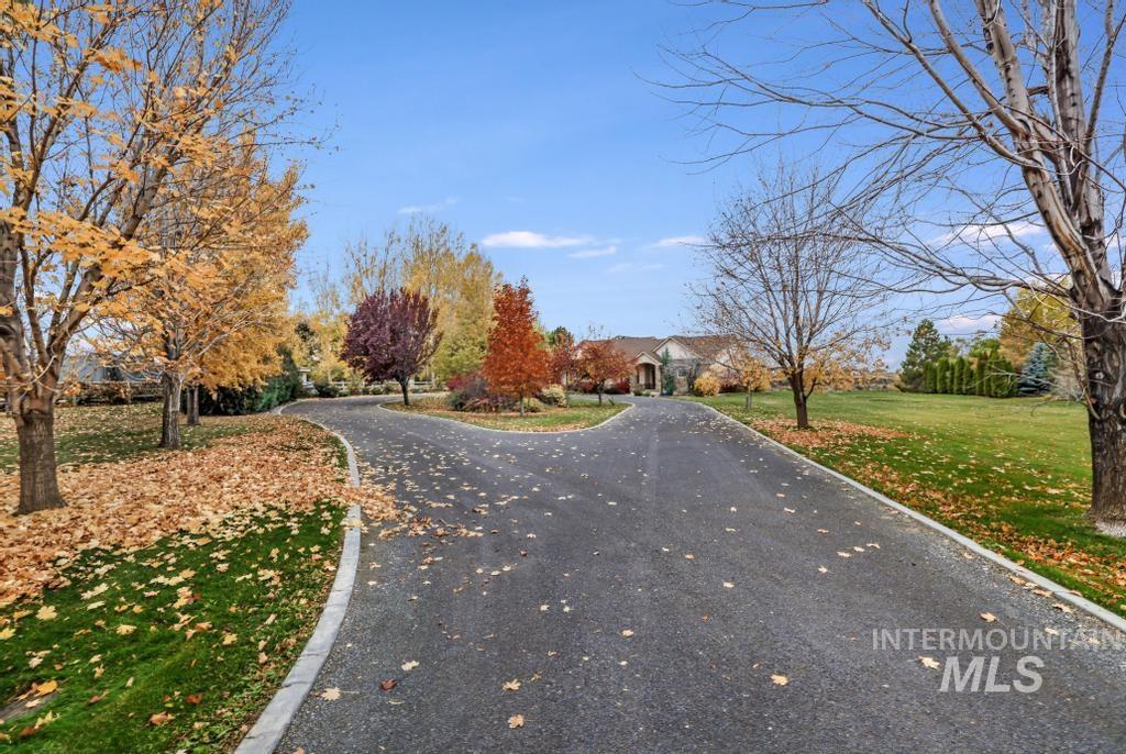 View of asphalt road featuring curbs