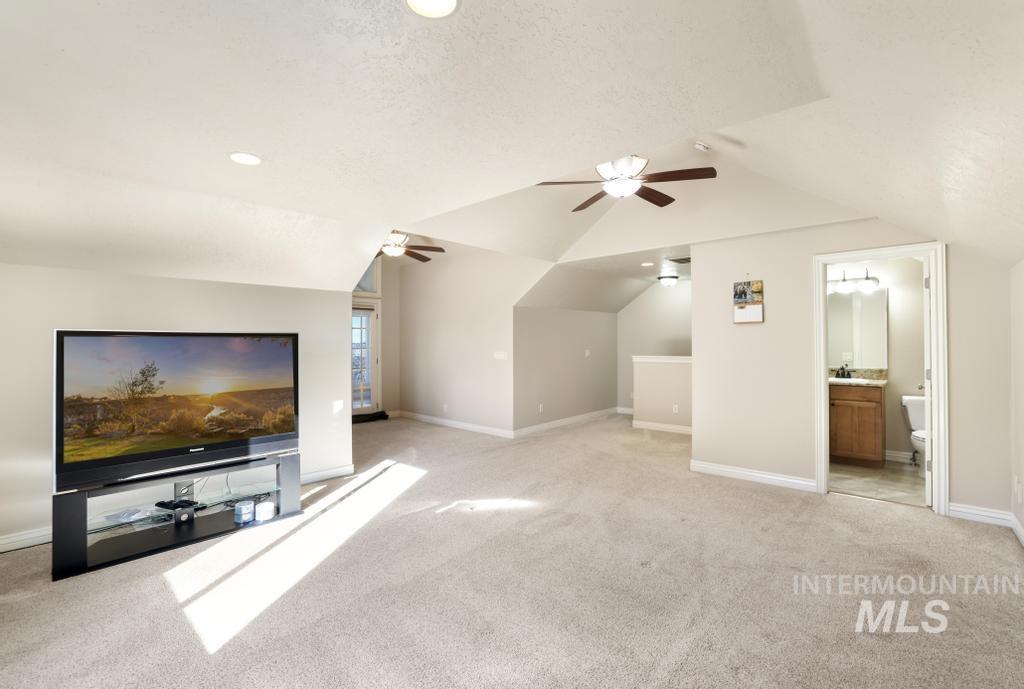 Bonus room with light carpet, a textured ceiling, recessed lighting, and vaulted ceiling