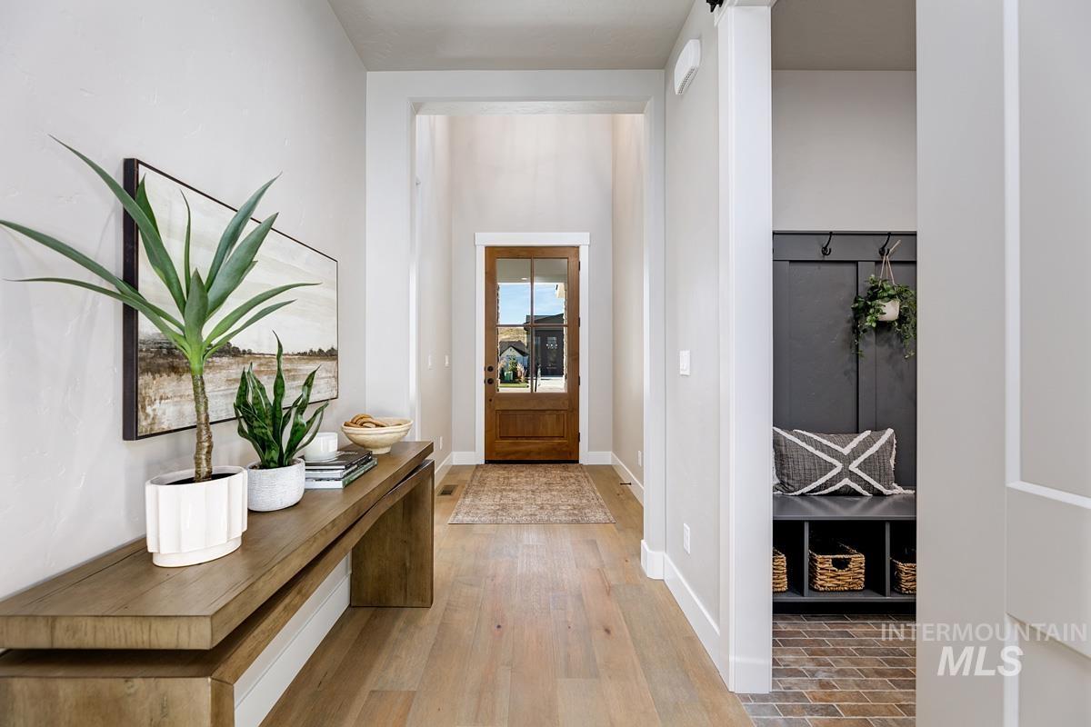 Foyer with wood-type flooring and baseboards