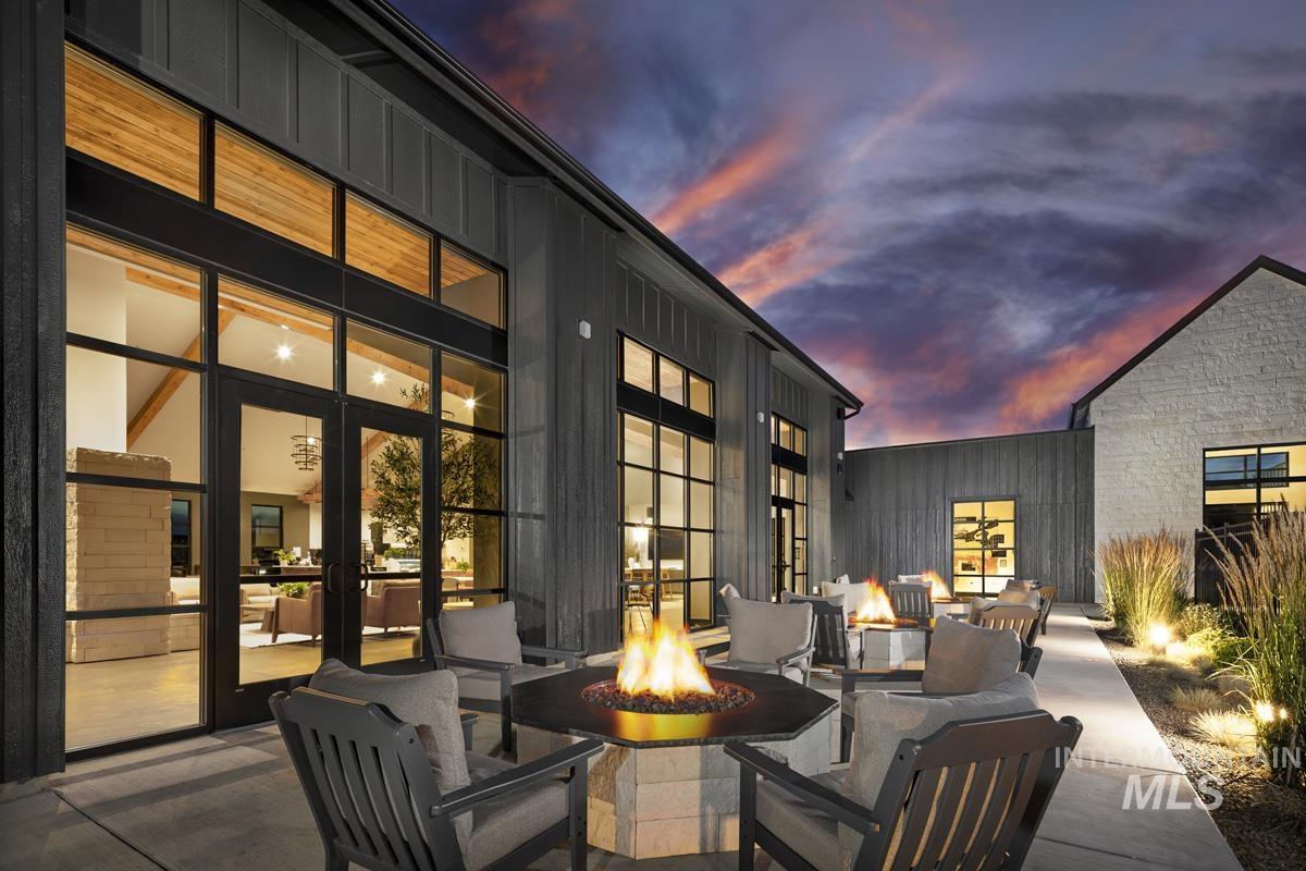 Patio terrace at dusk with a patio area and a fire pit