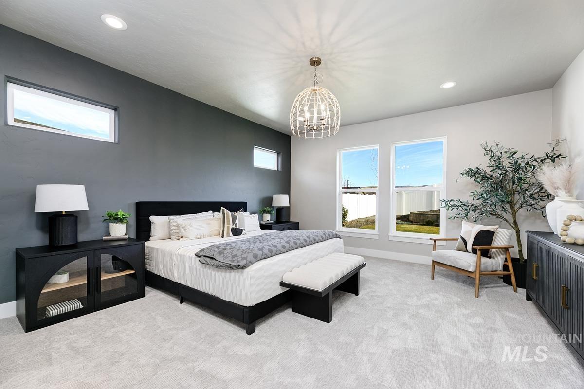 Bedroom featuring recessed lighting, light colored carpet, and a chandelier