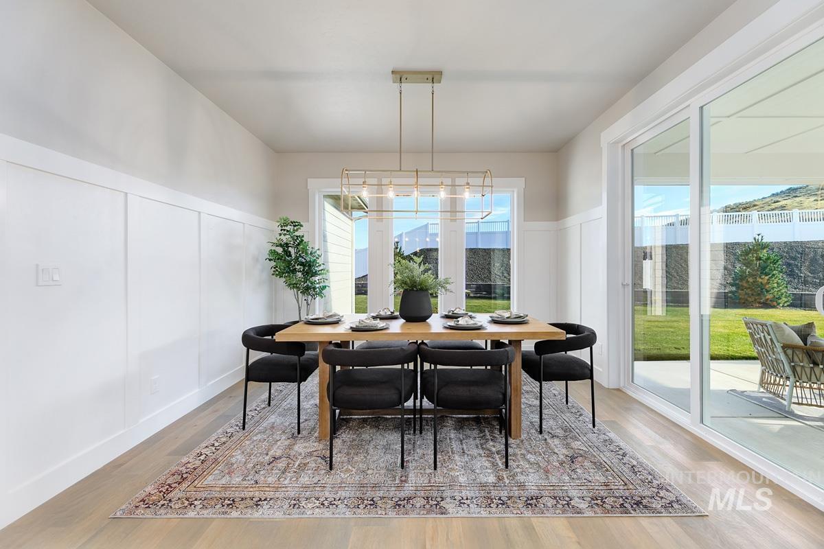 Dining area featuring a decorative wall and light wood finished floors
