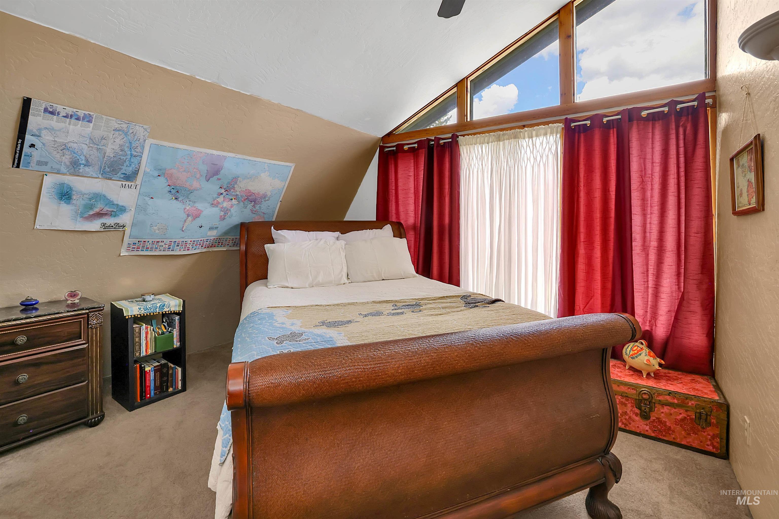 Bedroom with carpet, lofted ceiling, and a ceiling fan