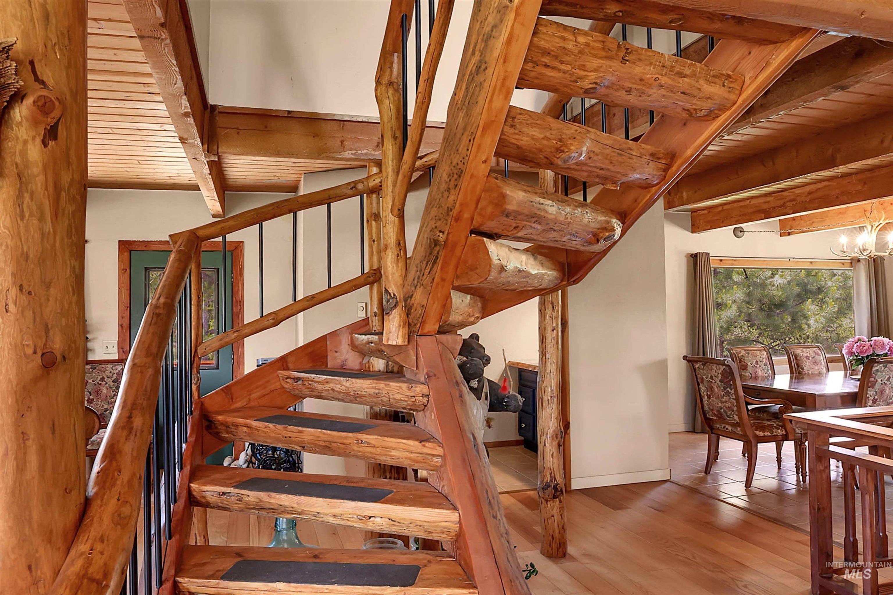 Stairs with beamed ceiling and wood finished floors