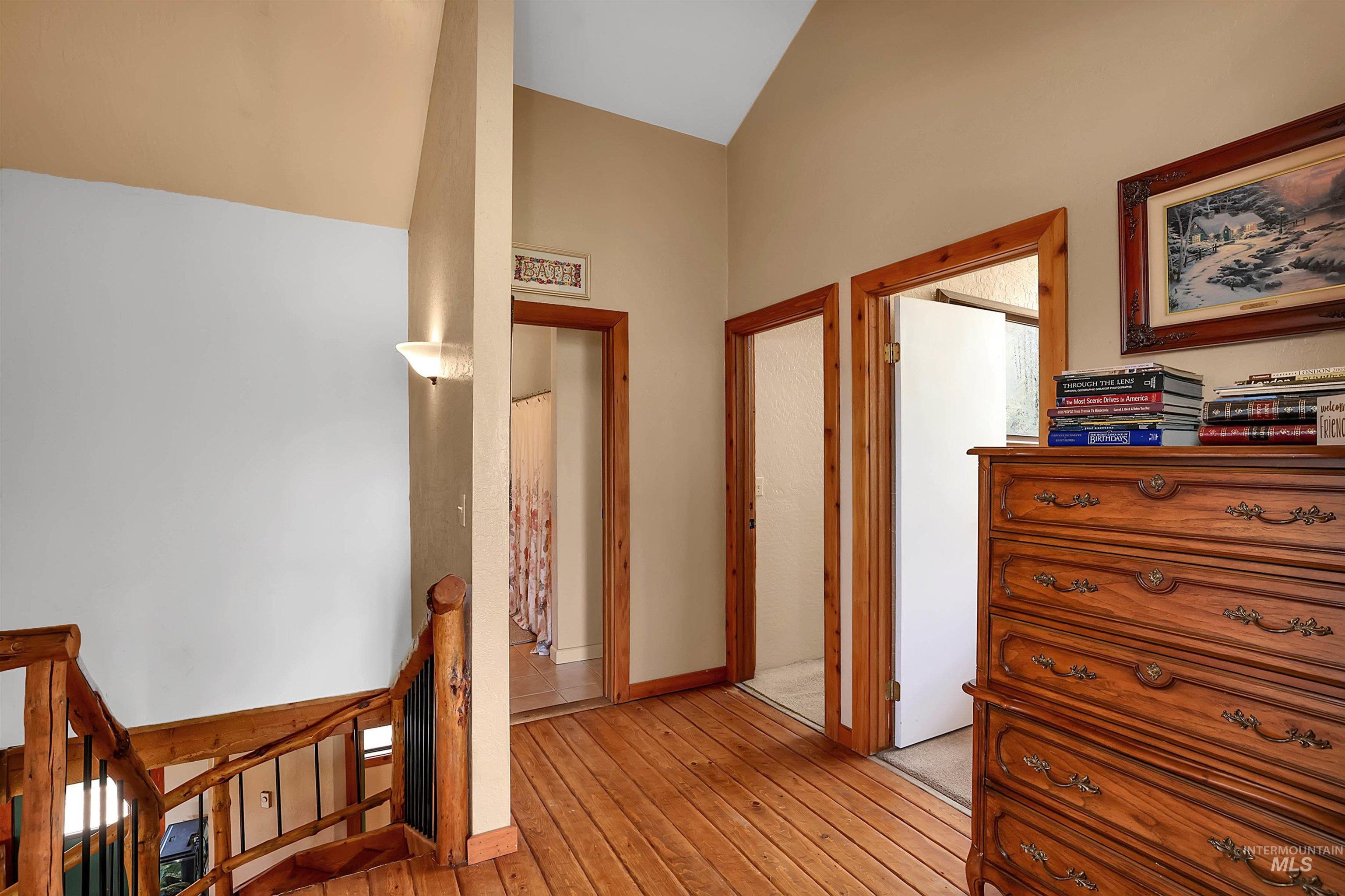 Hallway featuring an upstairs landing and light wood-type flooring