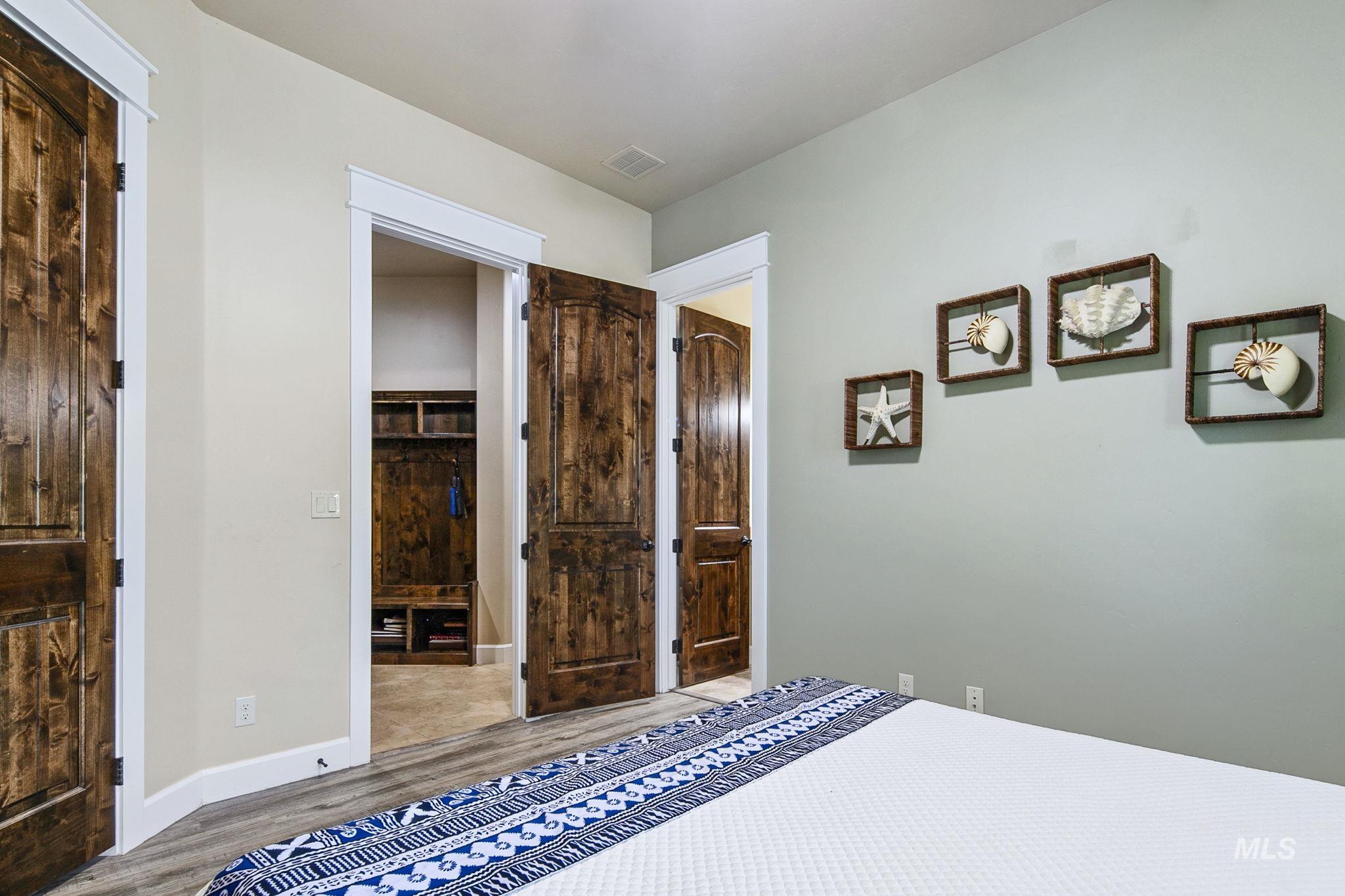 Spacious main-level guest suite offers a private en suite bathroom, elevated finishes, and comfortable accommodations for family or guests