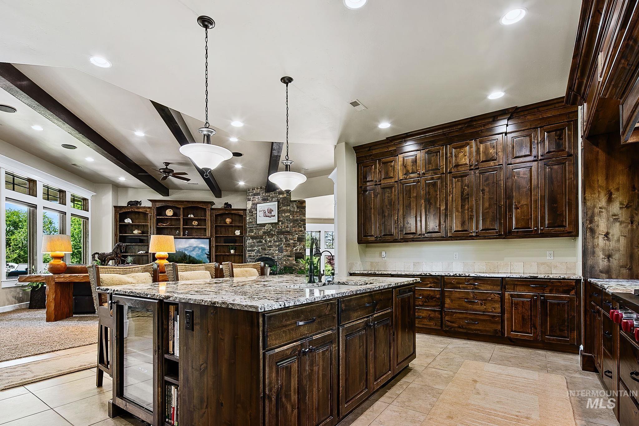 Open-concept kitchen with oversized island, custom millwork, and seamless flow into the great room