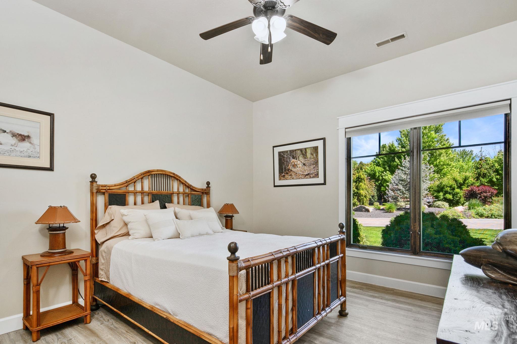 Spacious main-level guest suite offers a private en suite bathroom, elevated finishes, and comfortable accommodations for family or guests