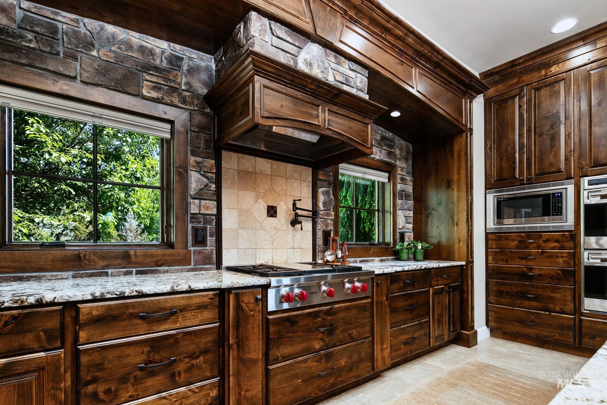 Designed for both everyday living and entertaining, this gourmet kitchen features double ovens, a large center island, and custom cabinetry throughout