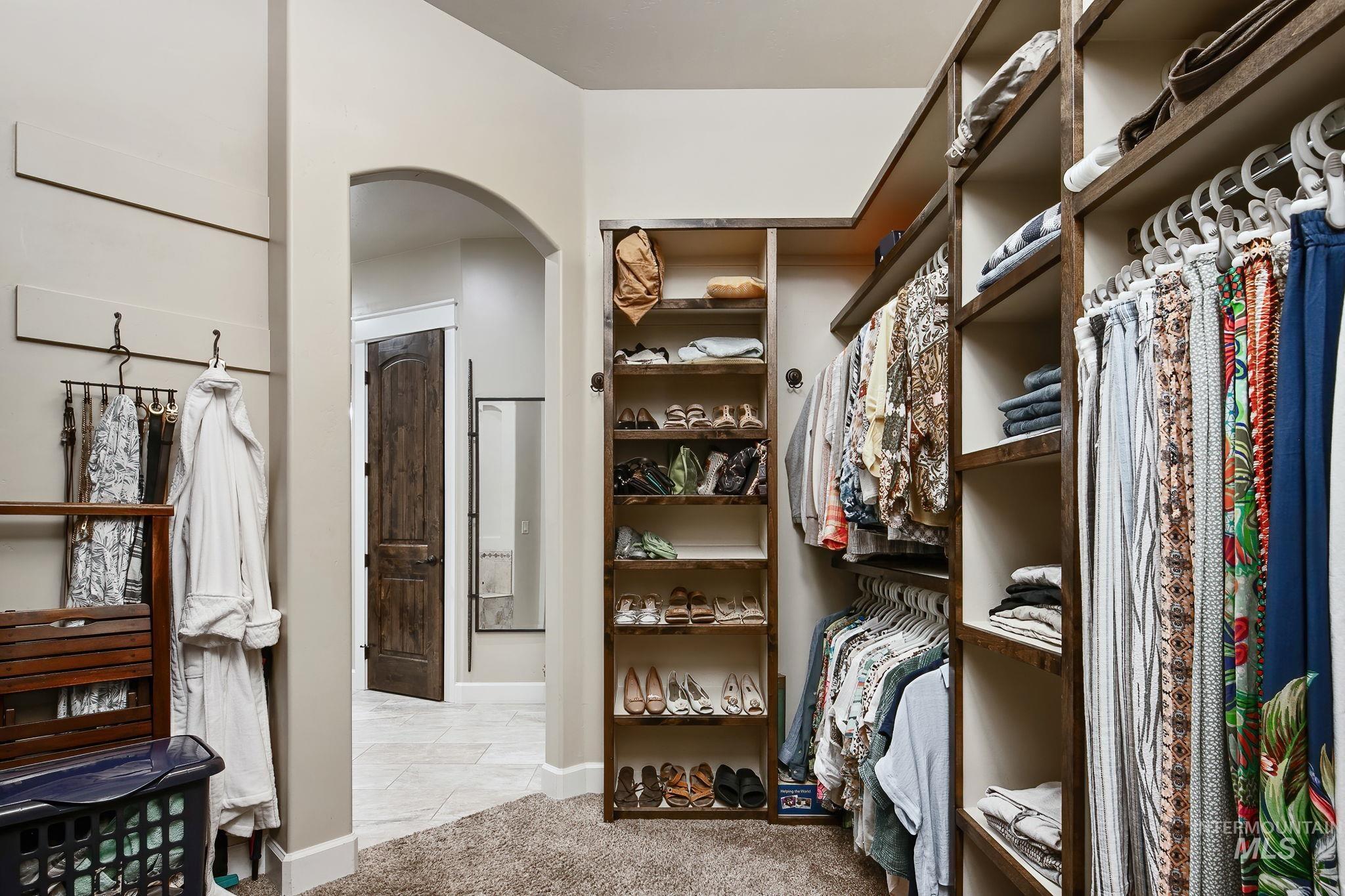 Spacious walk-in closet with custom built-ins, abundant storage, and boutique-style organization