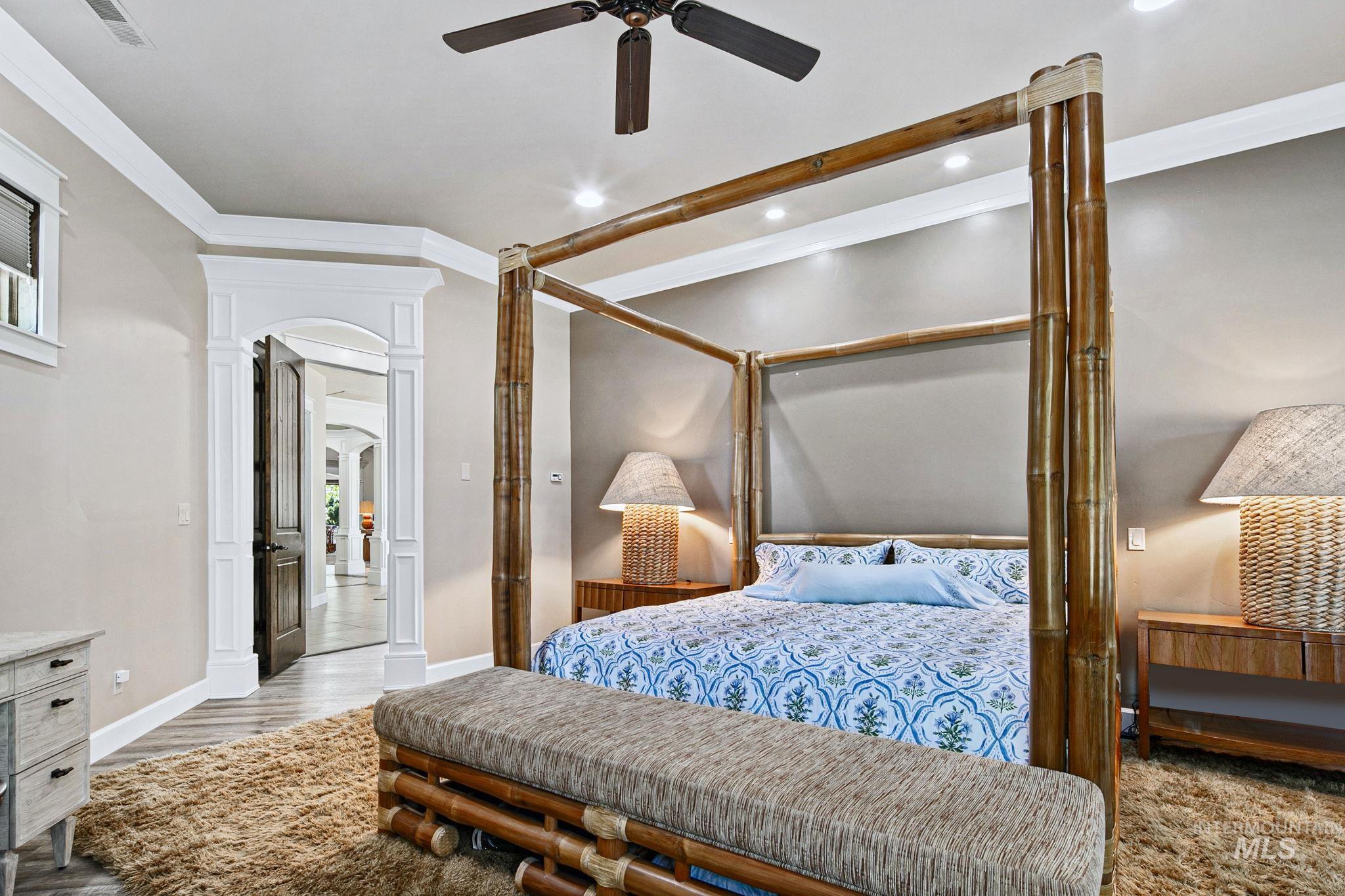 Serene primary bedroom retreat with oversized proportions, custom trim details, and resort-inspired design elements