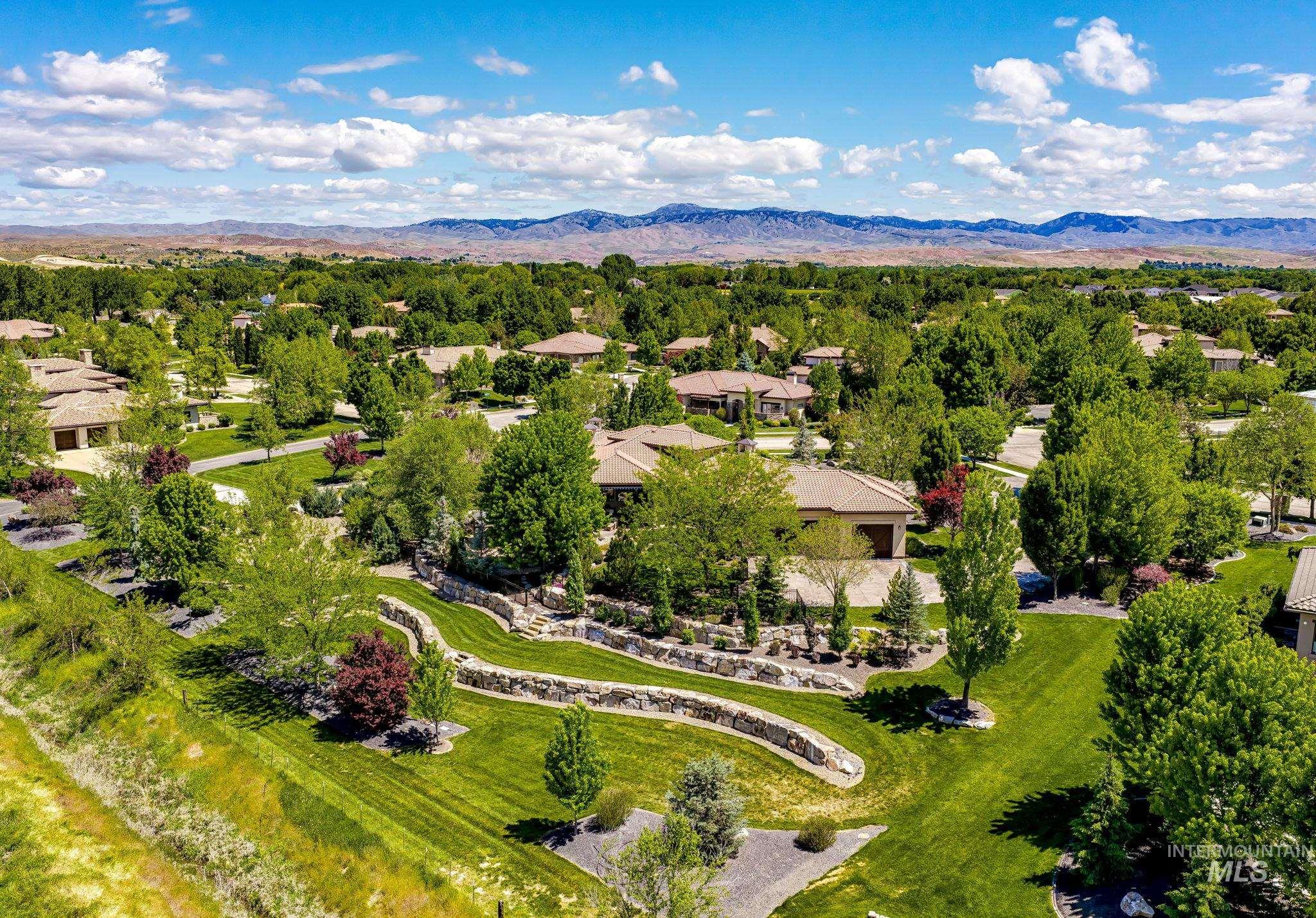 Aerial view featuring multiple tier stone retaining wall and landscaping