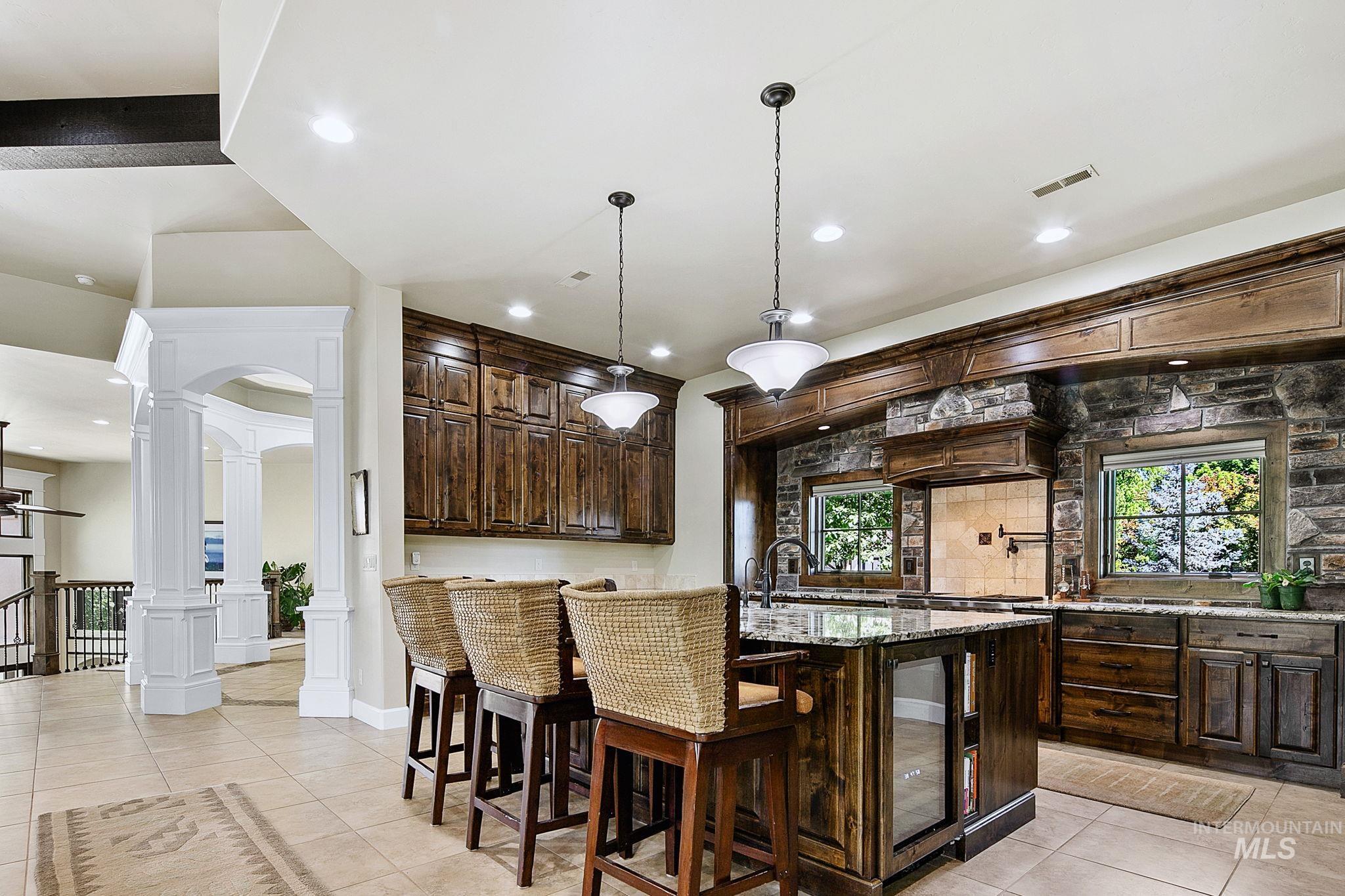 Entertain with ease in this gourmet kitchen complete with granite countertops, expansive prep space, and custom wood finishes