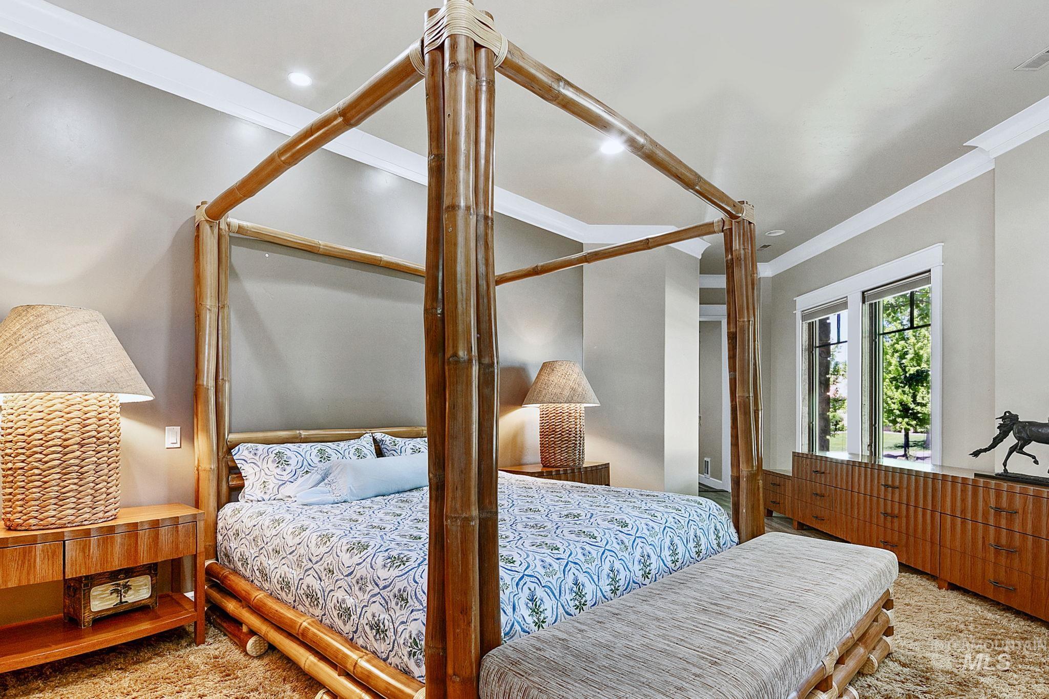 Serene primary bedroom retreat with oversized proportions, custom trim details, and resort-inspired design elements