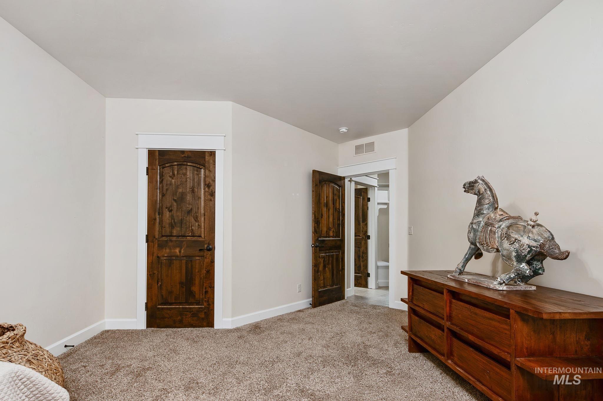 Additional lower-level en suite bedroom offering privacy and comfort for guests, complete with its own full bathroom and spacious layout