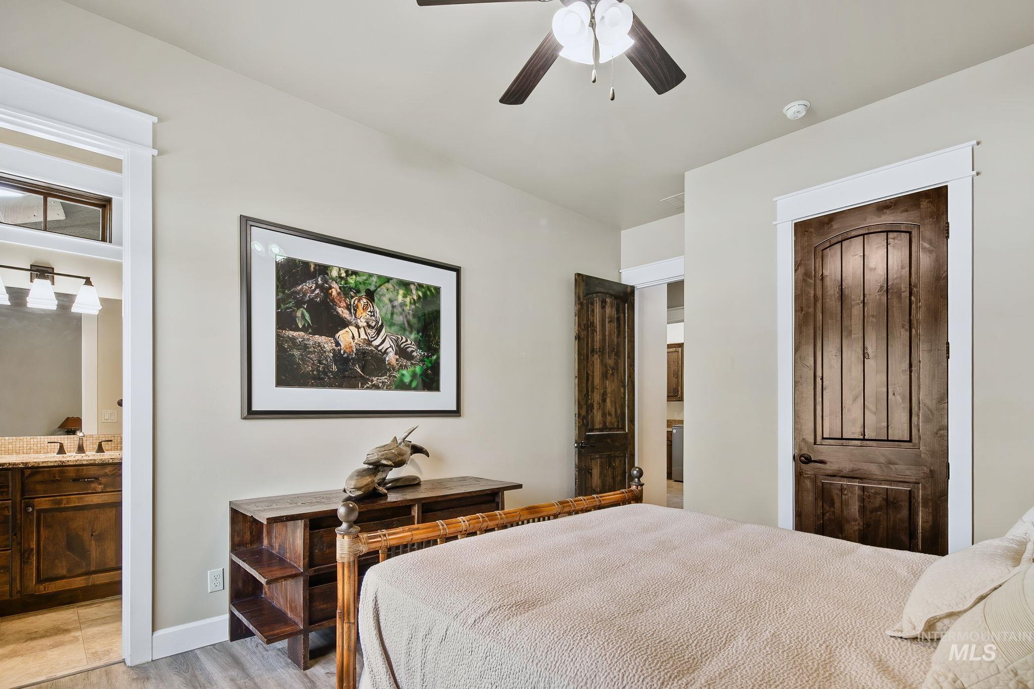 Spacious main-level guest suite offers a private en suite bathroom, elevated finishes, and comfortable accommodations for family or guests