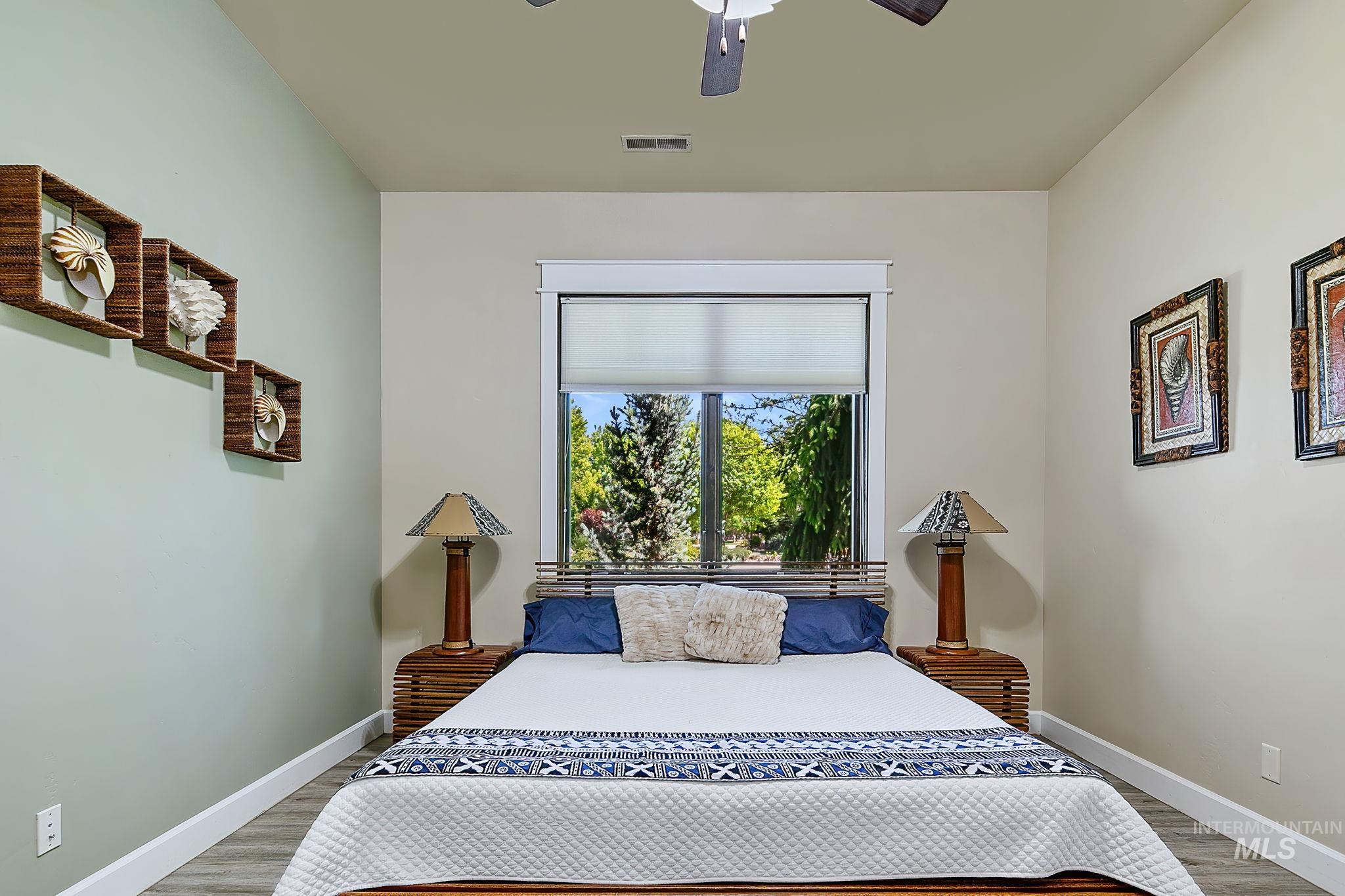 Spacious main-level guest suite offers a private en suite bathroom, elevated finishes, and comfortable accommodations for family or guests