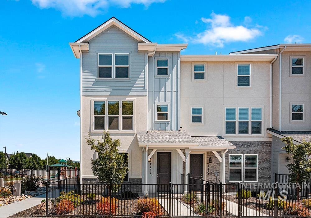 View of front of house featuring a fenced front yard and stucco siding