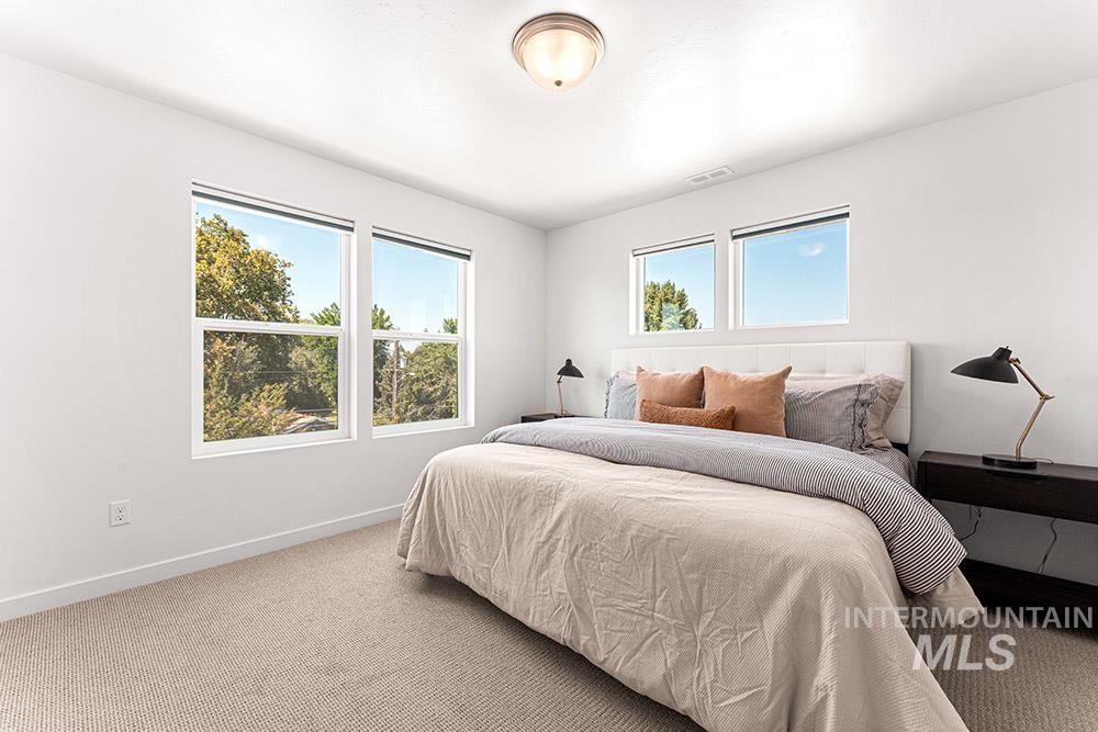 Carpeted bedroom featuring baseboards