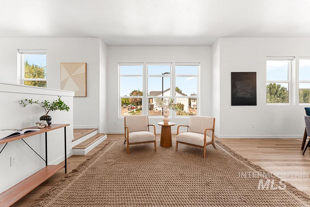 Living area with healthy amount of natural light and light wood-style flooring