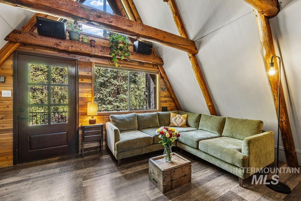 Living area featuring wood finished floors and wooden walls