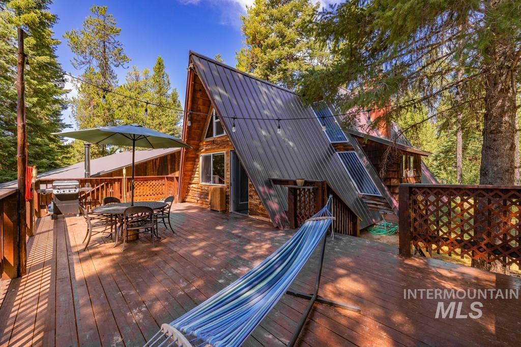 Wooden terrace featuring outdoor dining area