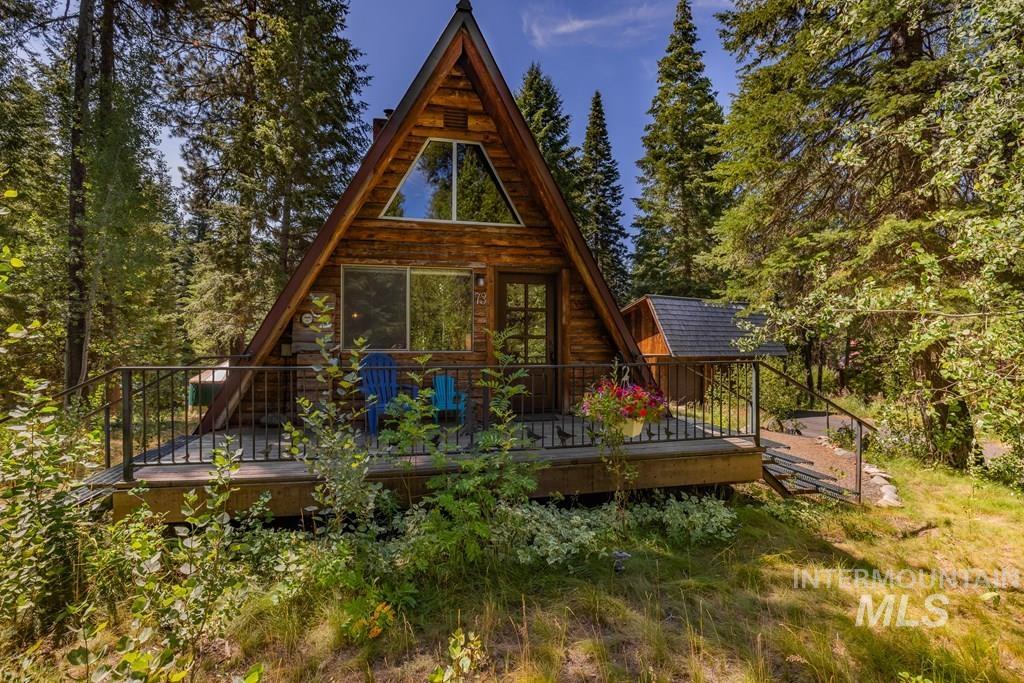 Back of property featuring a wooden deck