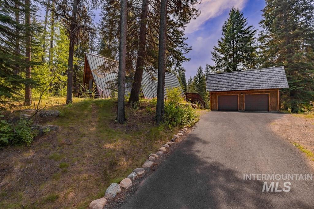 View of side of property with an outbuilding and a garage