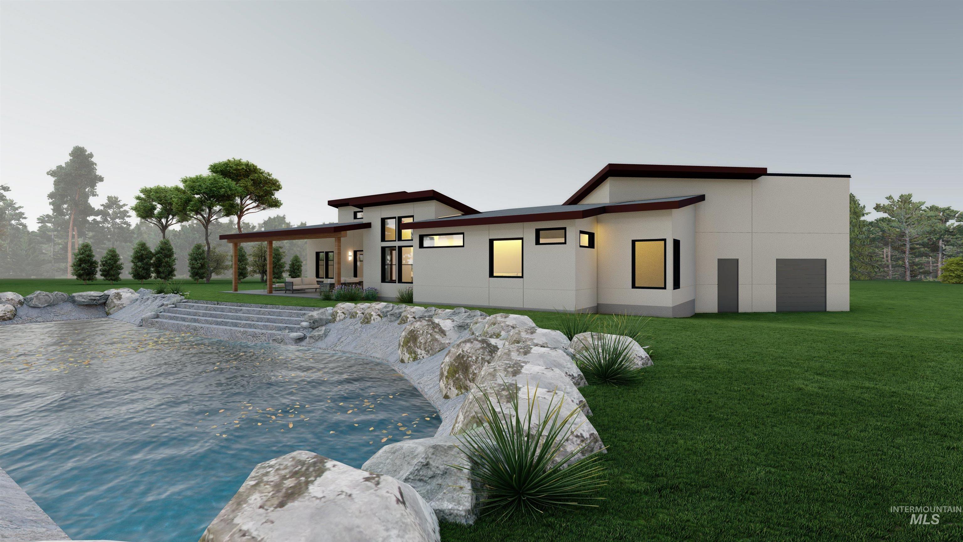 Rear view of house with a yard, stucco siding, and a covered patio, boulders and a sandy beach