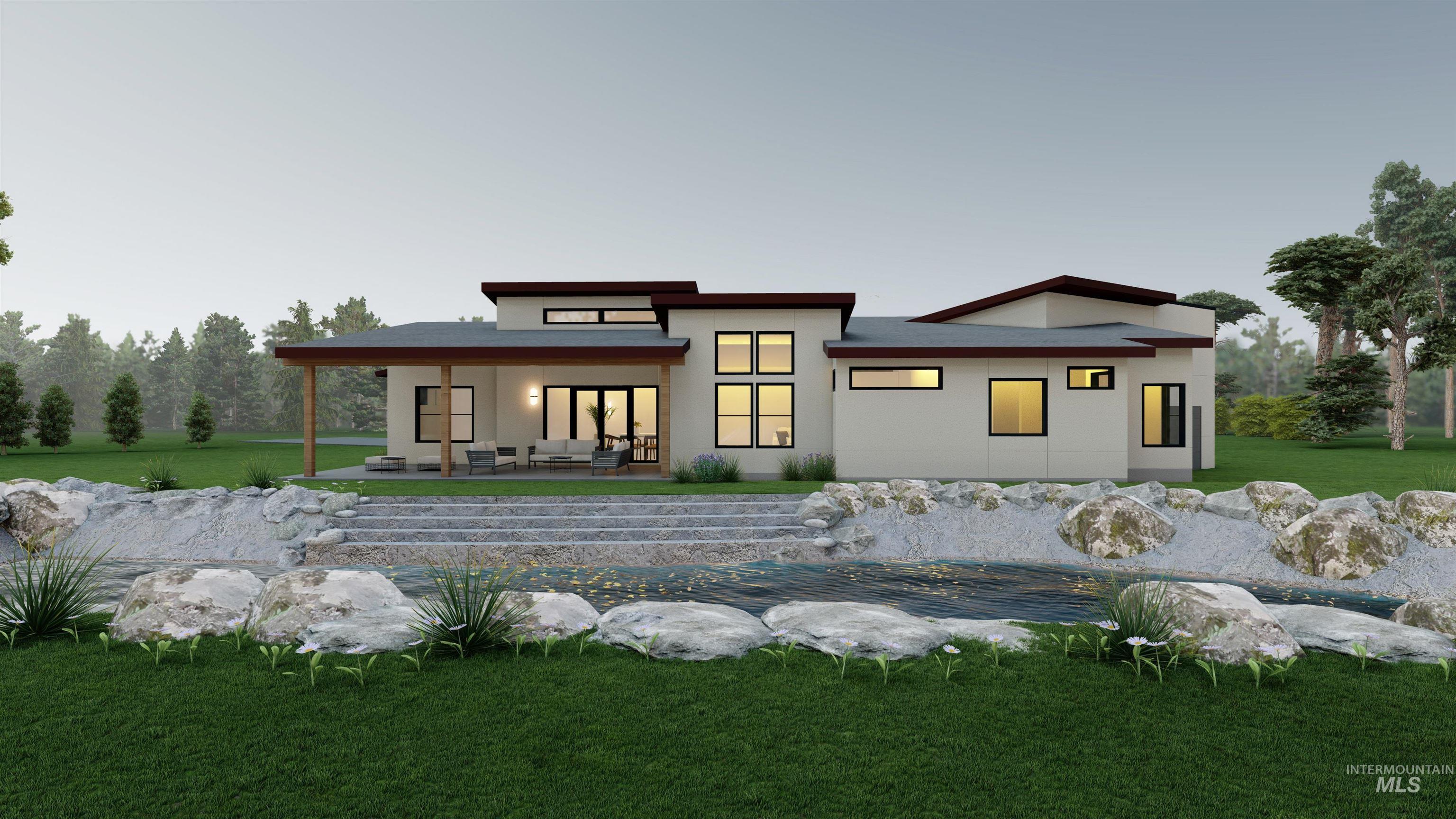 Back of property at dusk with a yard, stucco siding, and a patio area