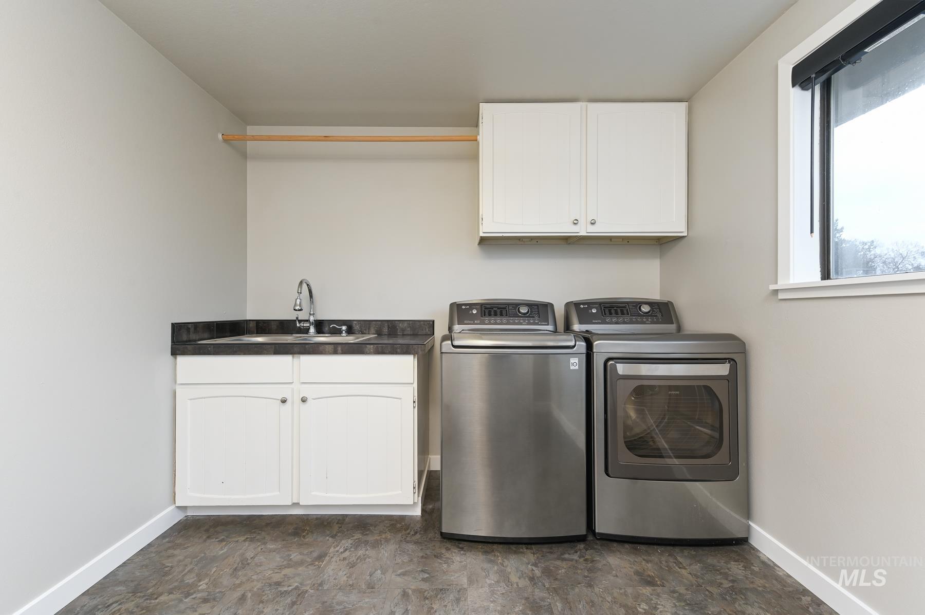 Laundry room featuring cabinet space and washing machine and clothes dryer