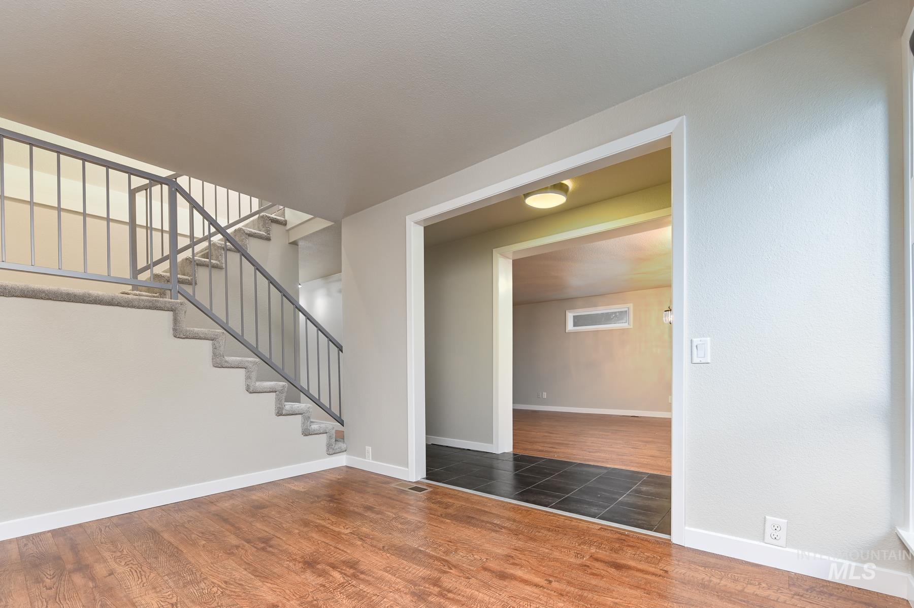 Stairs featuring wood finished floors