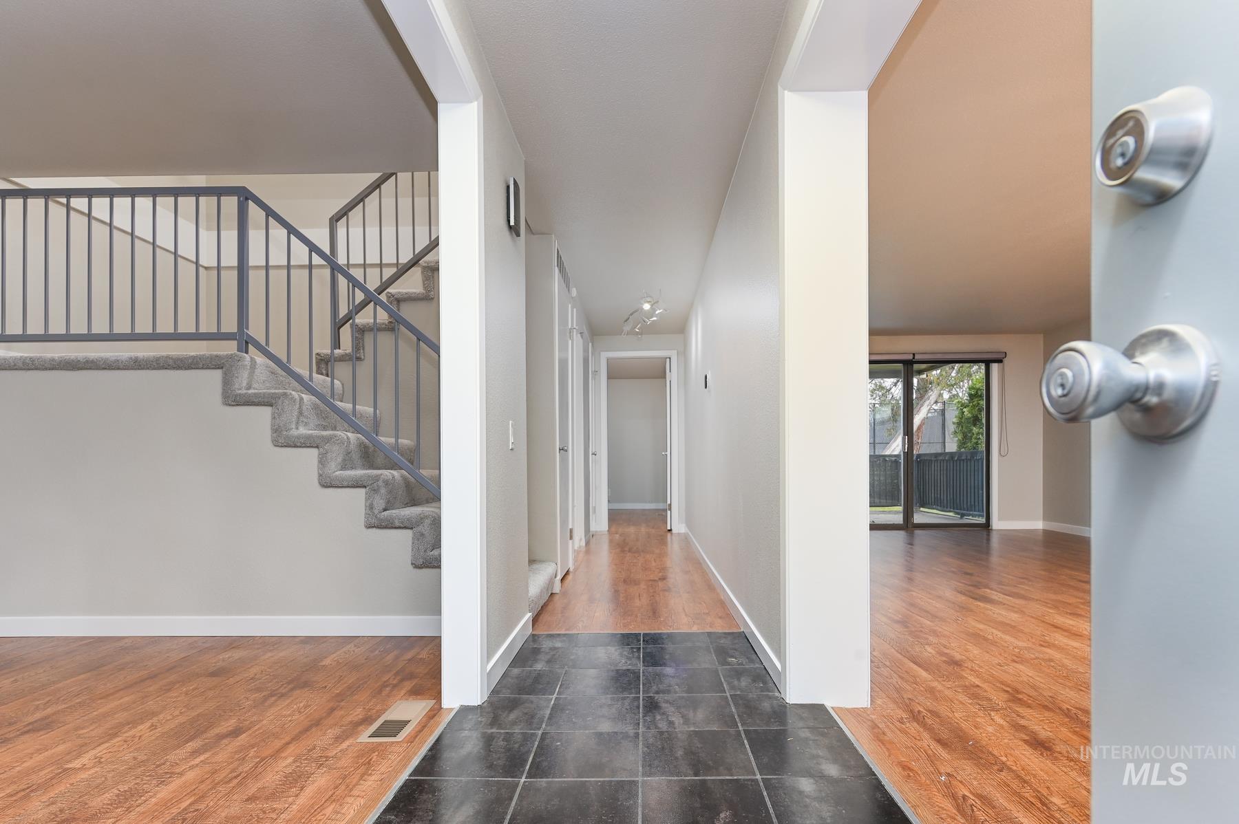 Entrance foyer with dark wood-style flooring