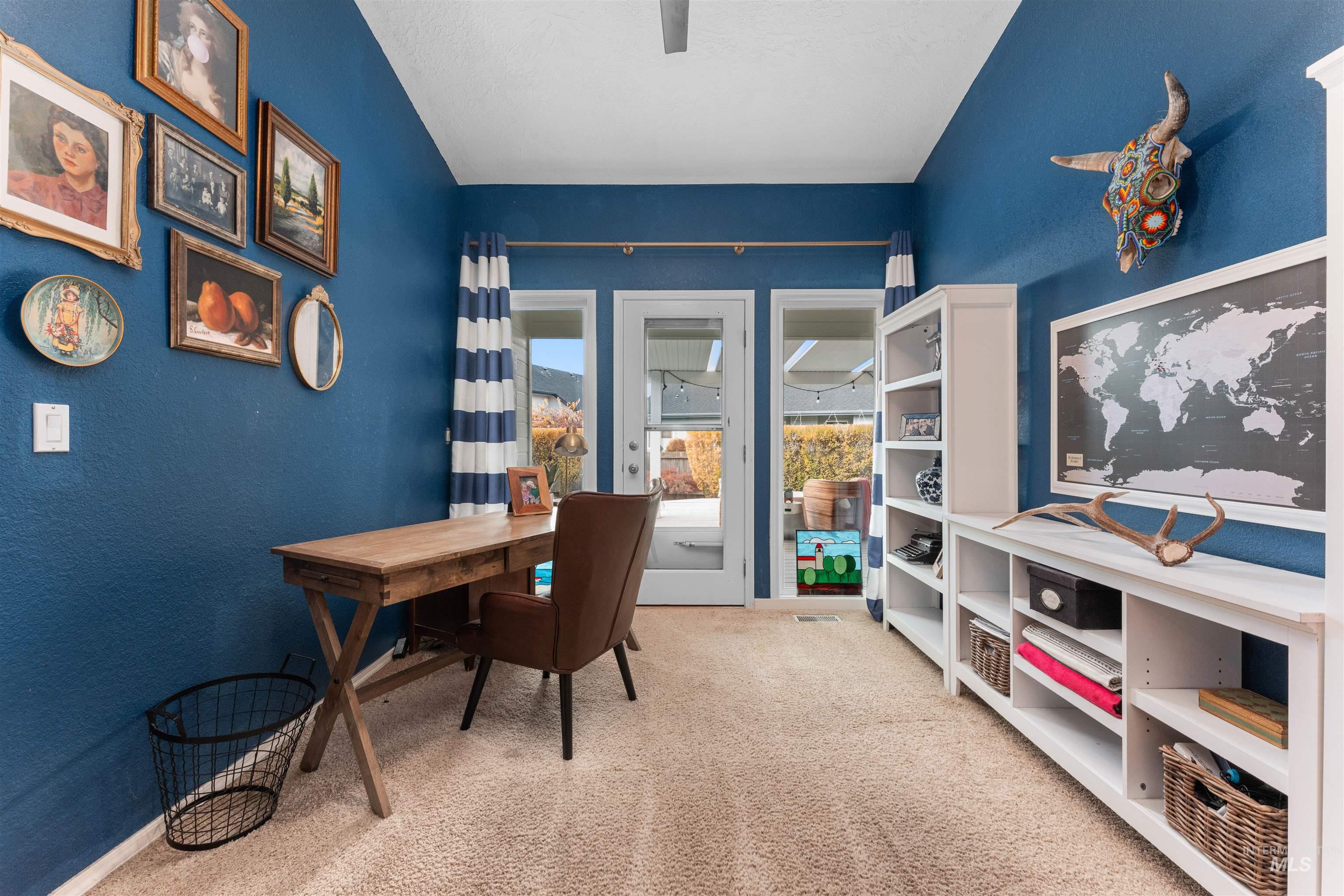 Office with a textured wall and light carpet