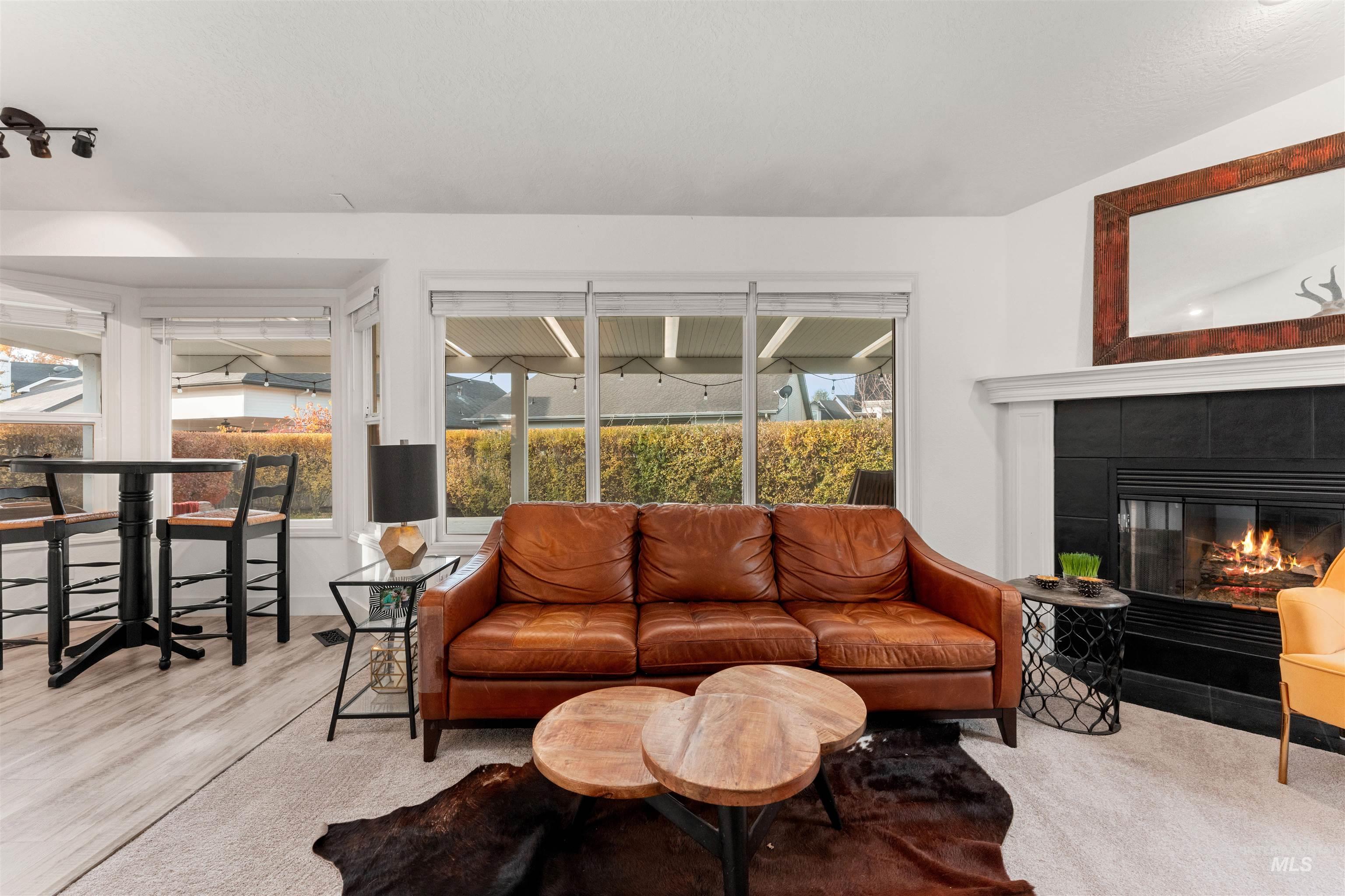 Living room featuring a tiled fireplace and wood finished floors