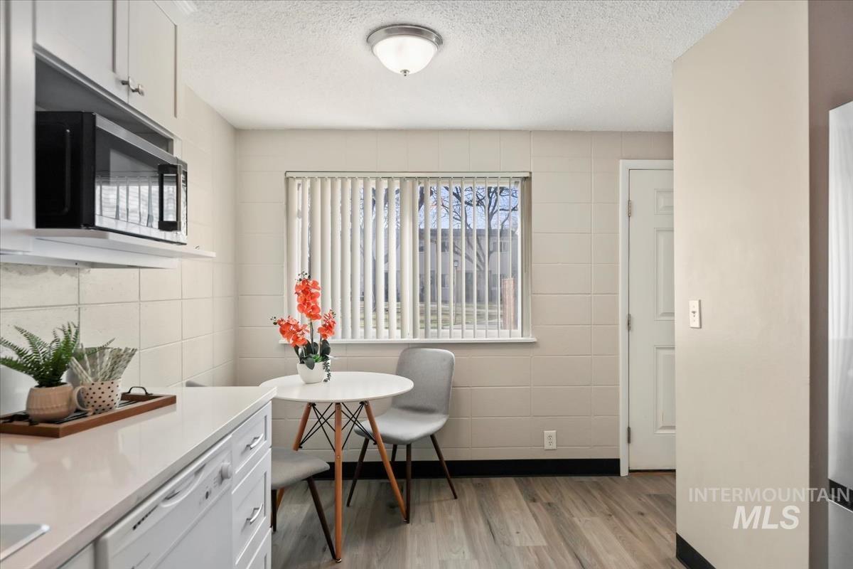 Dining room featuring light wood-style flooring and a textured ceiling