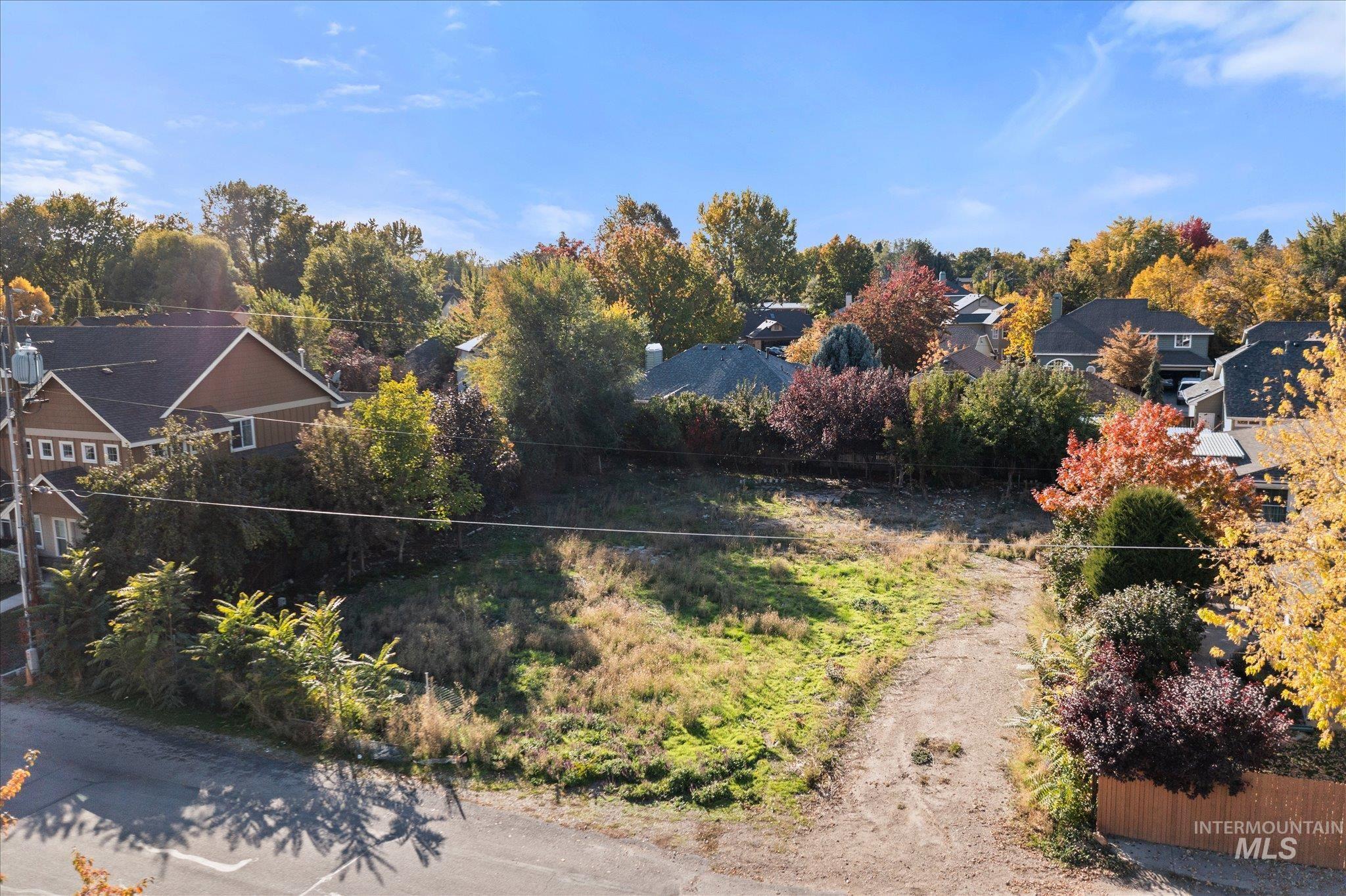 View of yard featuring a residential view and view of scattered trees