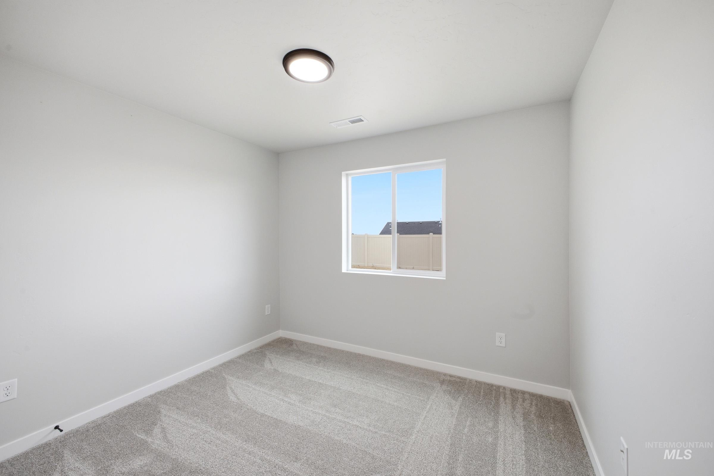 Bright room with gray carpet and white walls