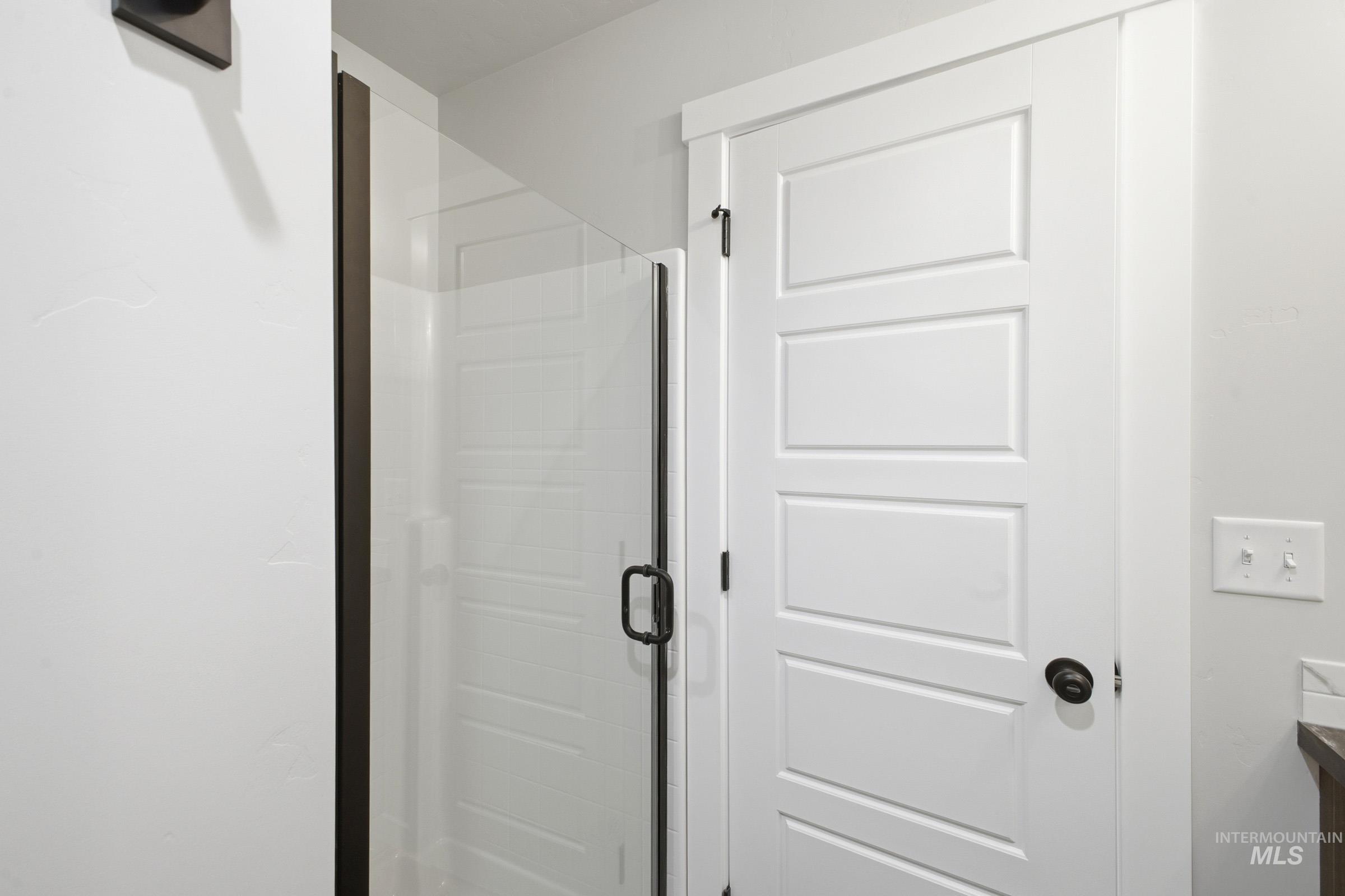 White four-panel interior door with dark hardware