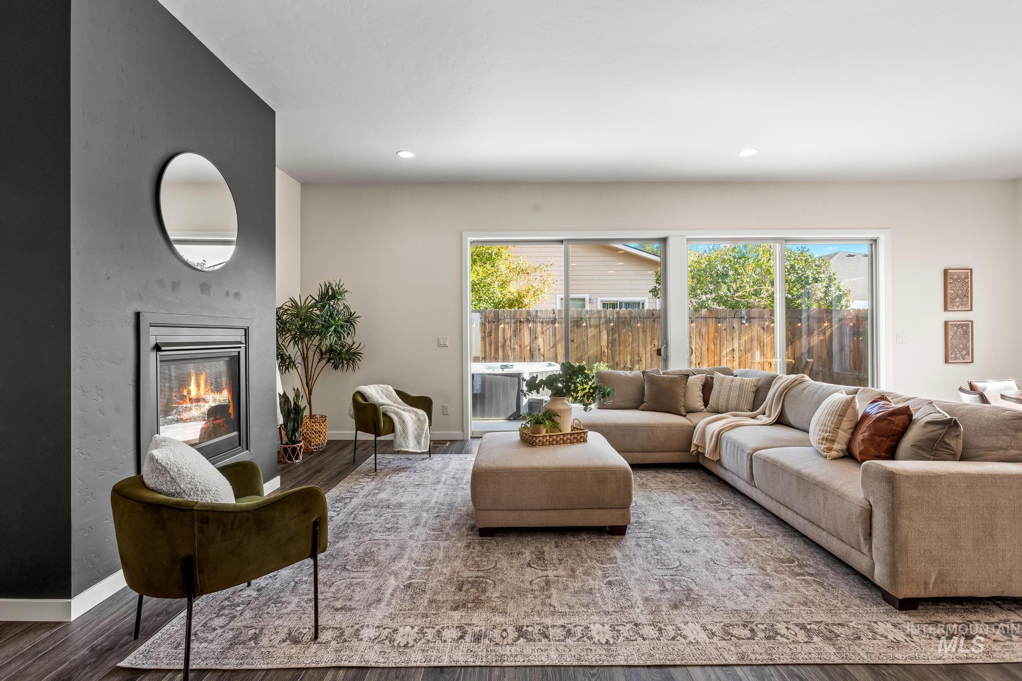 Living area with a fireplace, wood finished floors, and recessed lighting