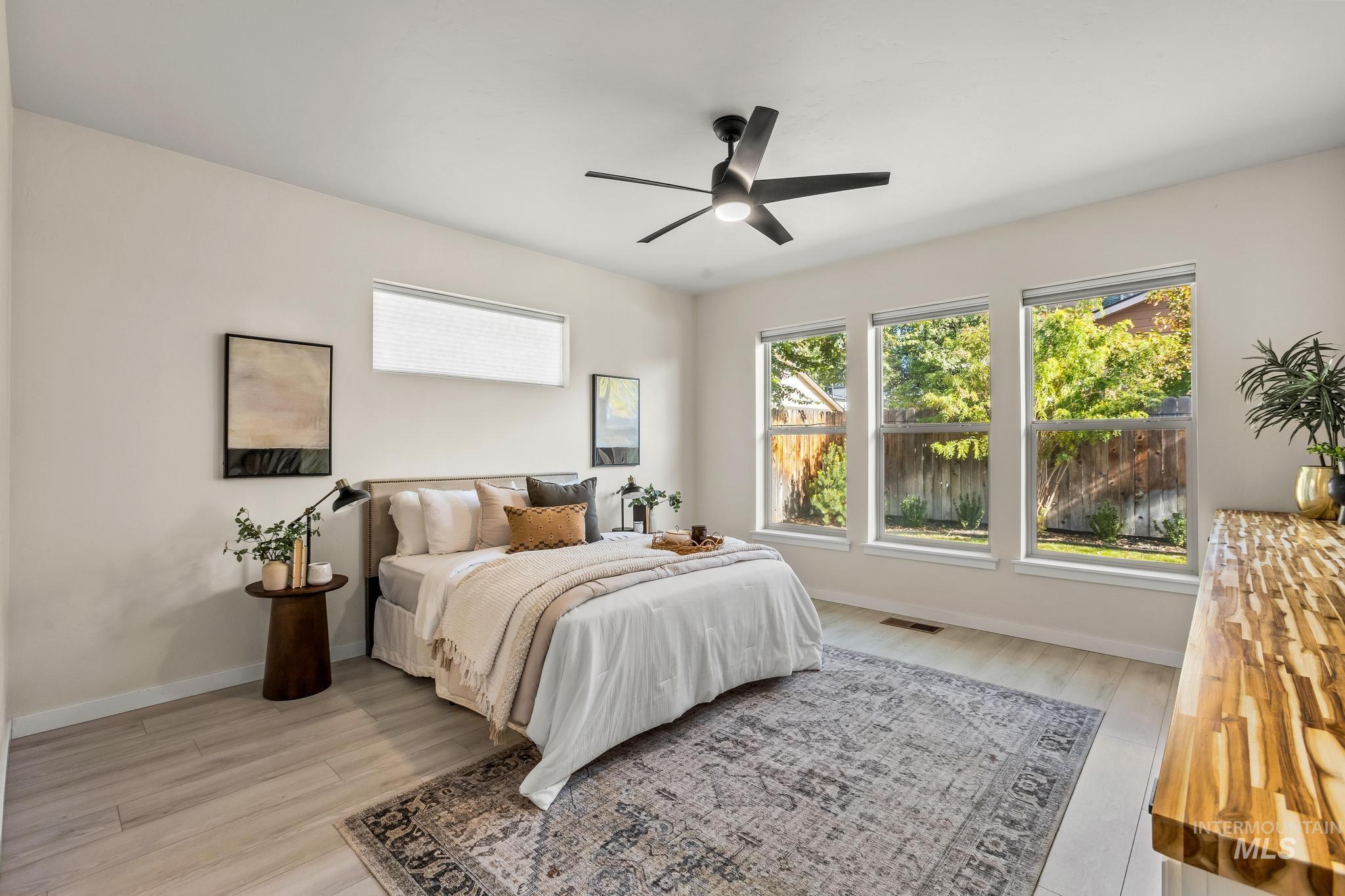 Bedroom with light wood-style floors and ceiling fan