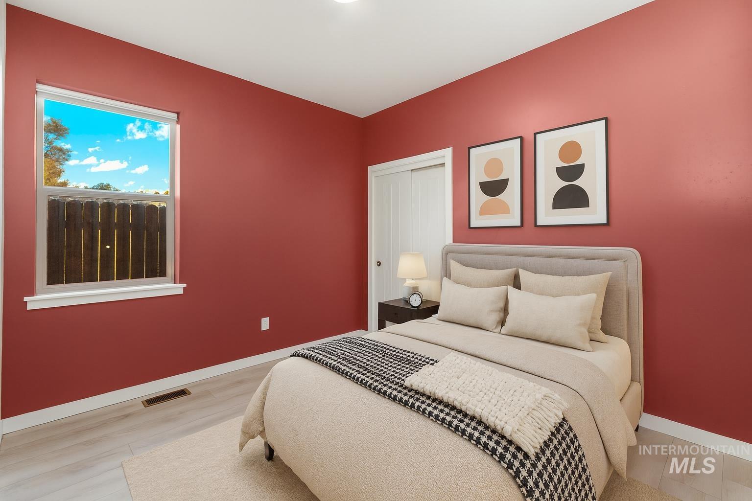 Bedroom featuring light wood-style floors and a closet