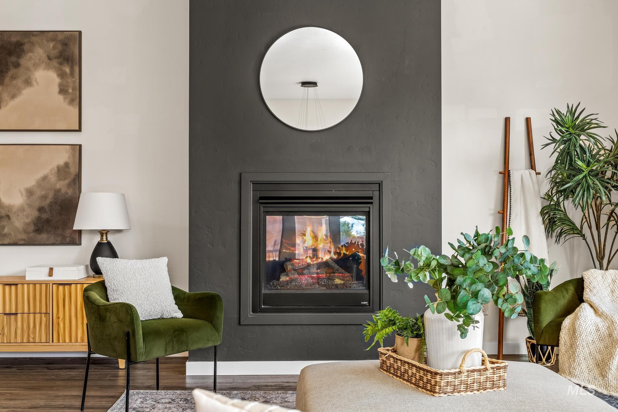 Living area featuring a multi sided fireplace and wood finished floors