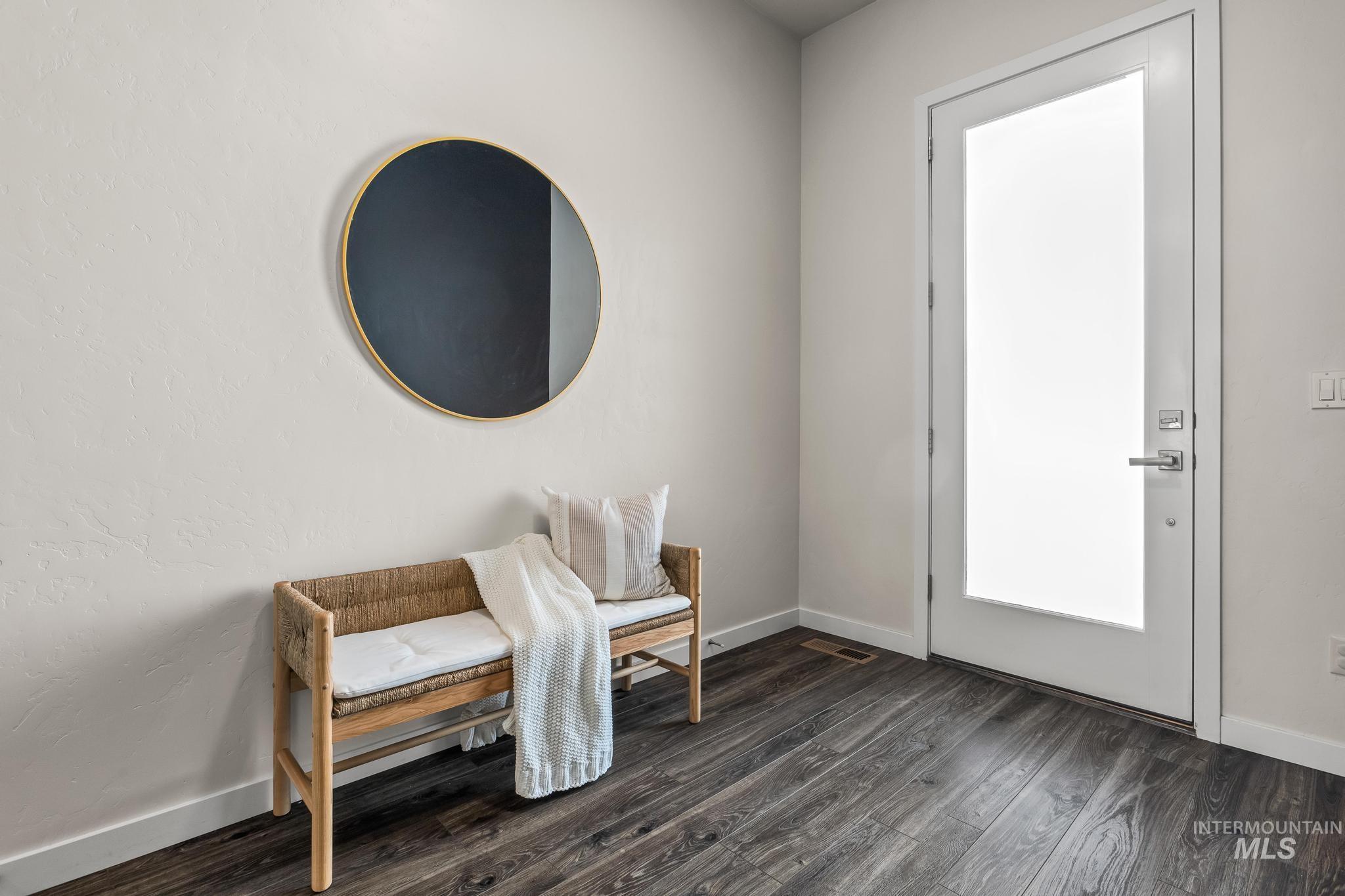 Entrance foyer featuring dark wood-type flooring